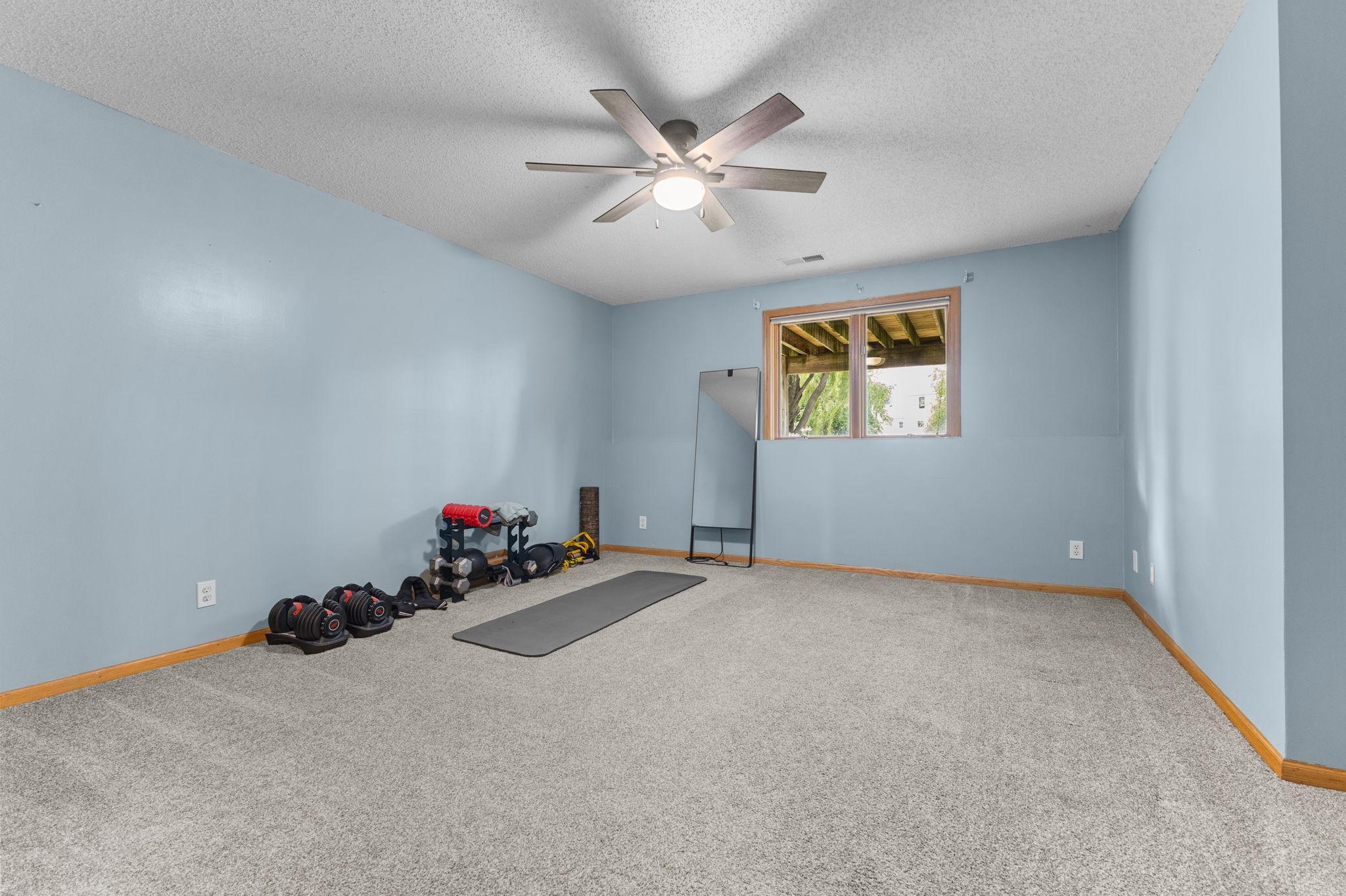 The fourth bedroom is located on the fourth level. It is currently being used as an exercise room but could also be used as a great playroom or home office!