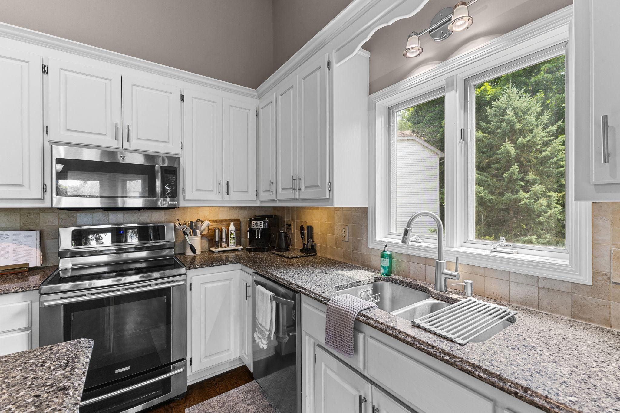 A window above the sink brings in natural light while overlooking the backyard.
