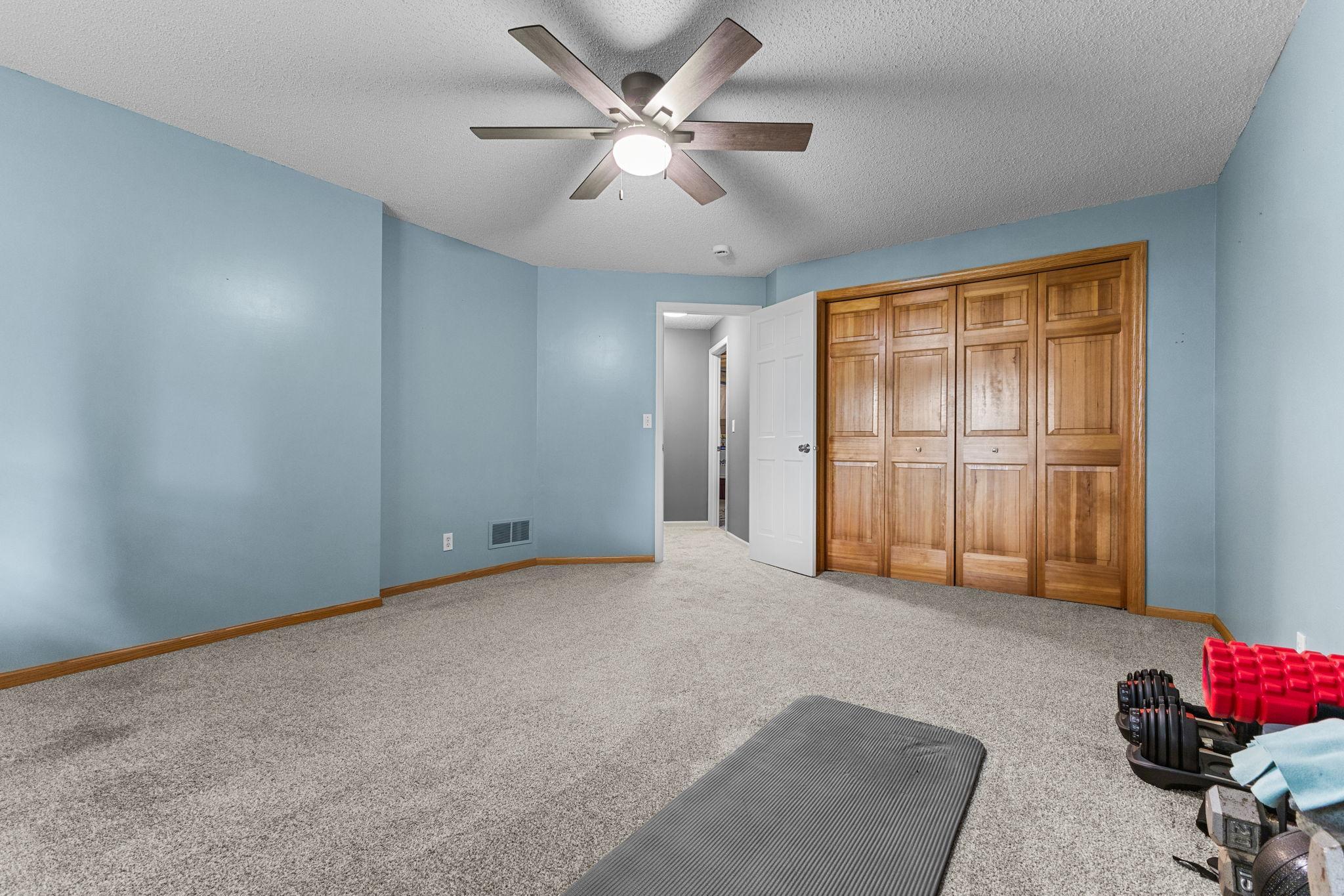 Spacious lower-level bedroom with another generous closet space.