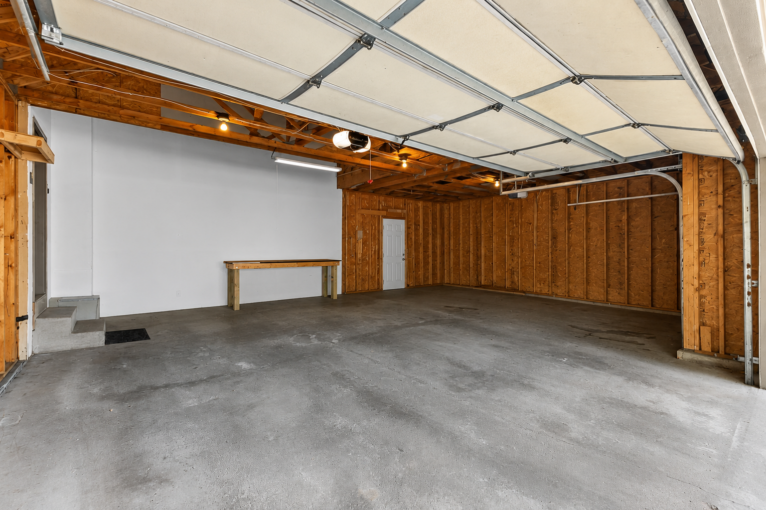 Oversized three-car garage with room for vehicles, tools, and outdoor gear.