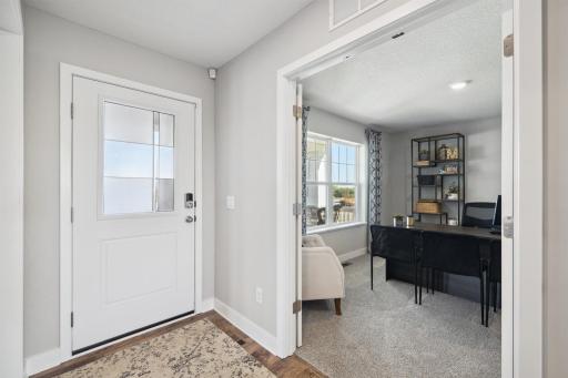 In addition to the vast living spaces on the main level, the home also includes this flex space, accessed by French doors - which can serve as a home office, toy room, formal dining area and more. Photo of model, colors and options will vary.