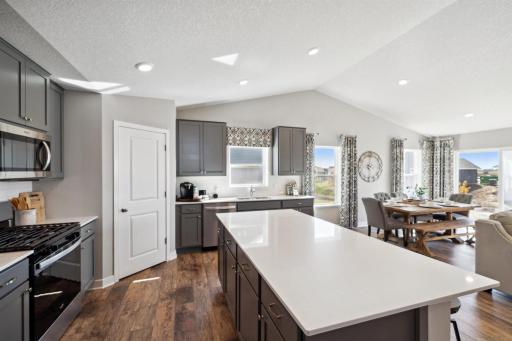 Stunning in every direction, the kitchen is also remarkably functional - leaving plenty of space for the family chef to maneuver and prepare that next meal. Photo of model, colors and options will vary.