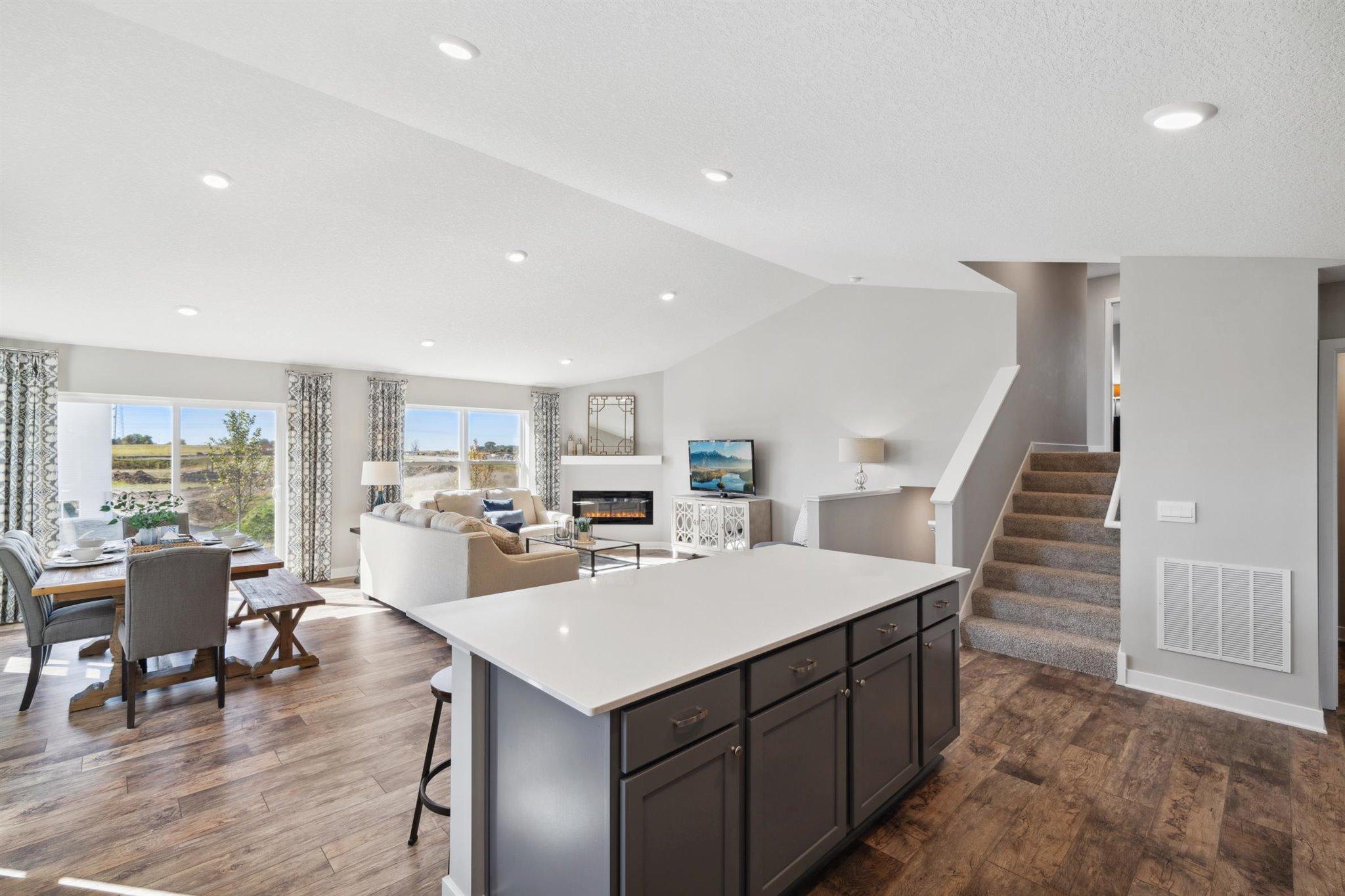 Natural light floods the entire layout, including the main level kitchen and dining spaces! Photo of model, colors and options will vary.