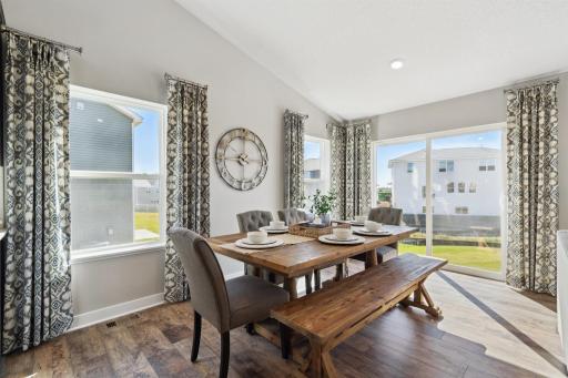 The home also features this dining area, which is large enough to accommodate just about any table and resides under the peak of a cathedral vault that hovers over the entire main level. Photo of model, colors and options will vary.