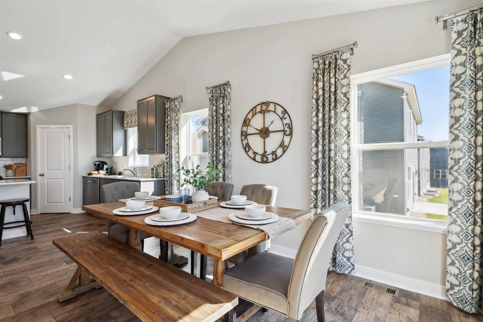 The home also features this dining area, which is large enough to accommodate just about any table and resides under the peak of a cathedral vault that hovers over the entire main level. Photo of model, colors and options will vary.