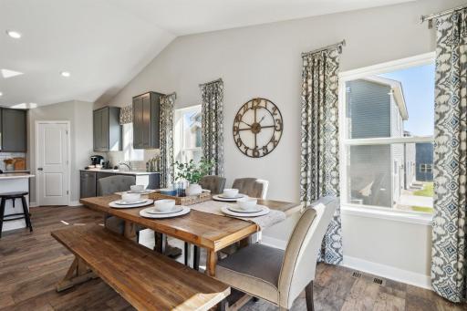 The home also features this dining area, which is large enough to accommodate just about any table and resides under the peak of a cathedral vault that hovers over the entire main level. Photo of model, colors and options will vary.