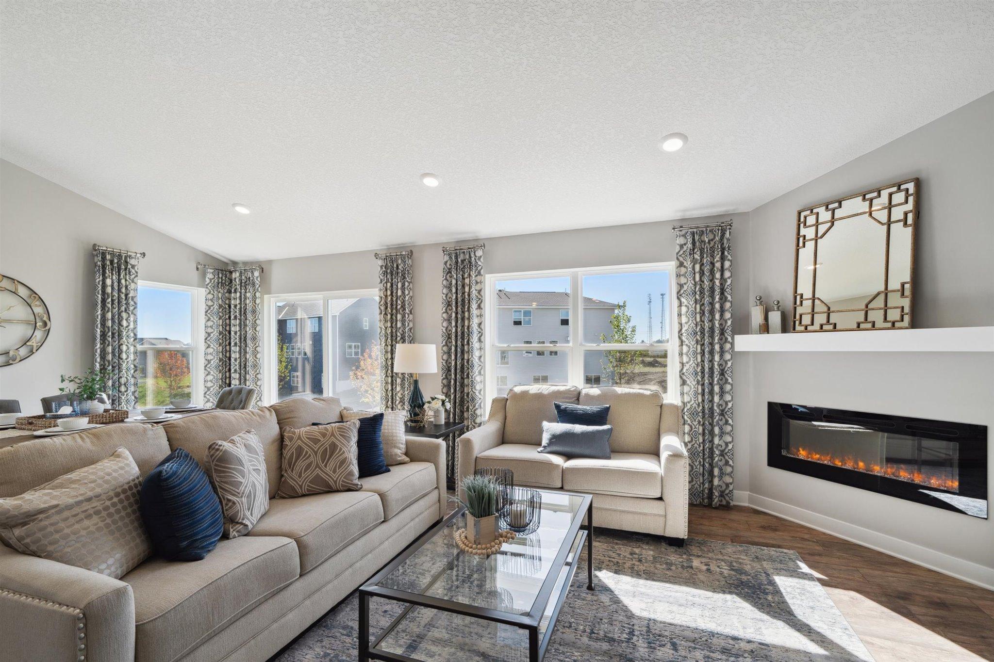 Opposite of the dining area, the home flows right into the main level living room. Photo of model, colors and options will vary.