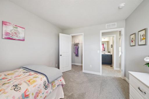 In addition to the primary bedroom, the home's upper level also includes these two additional bedrooms, and another full bathroom just adjacent to each! Photo of model, colors and options will vary.