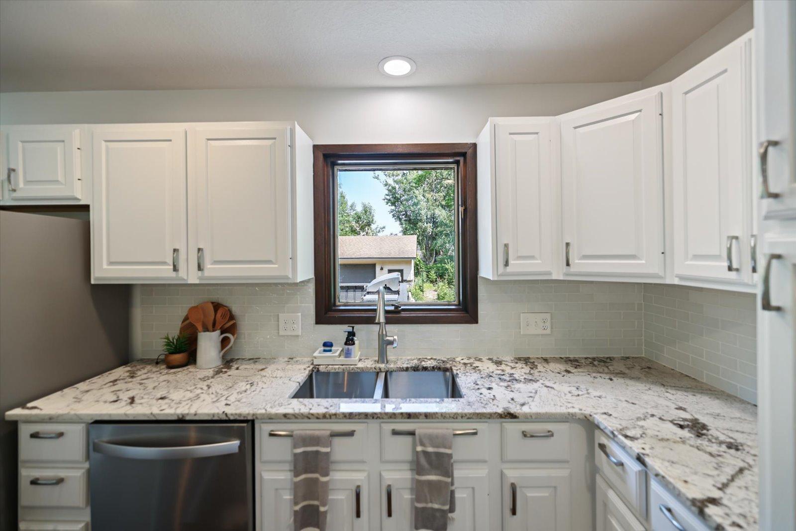 Newer kitchen sink, window views to the backyard