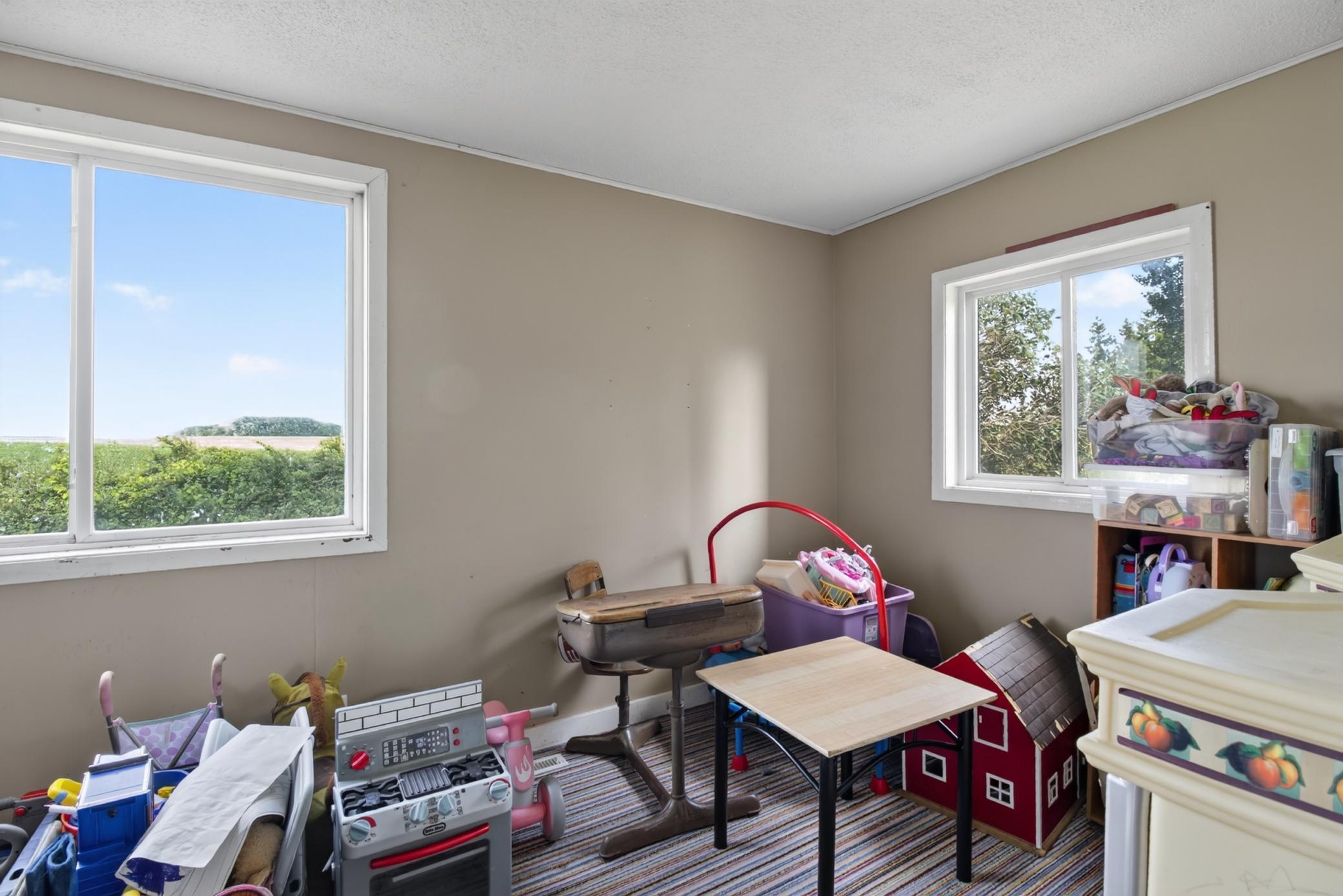 Porch with attached storage room, currently being used as playroom