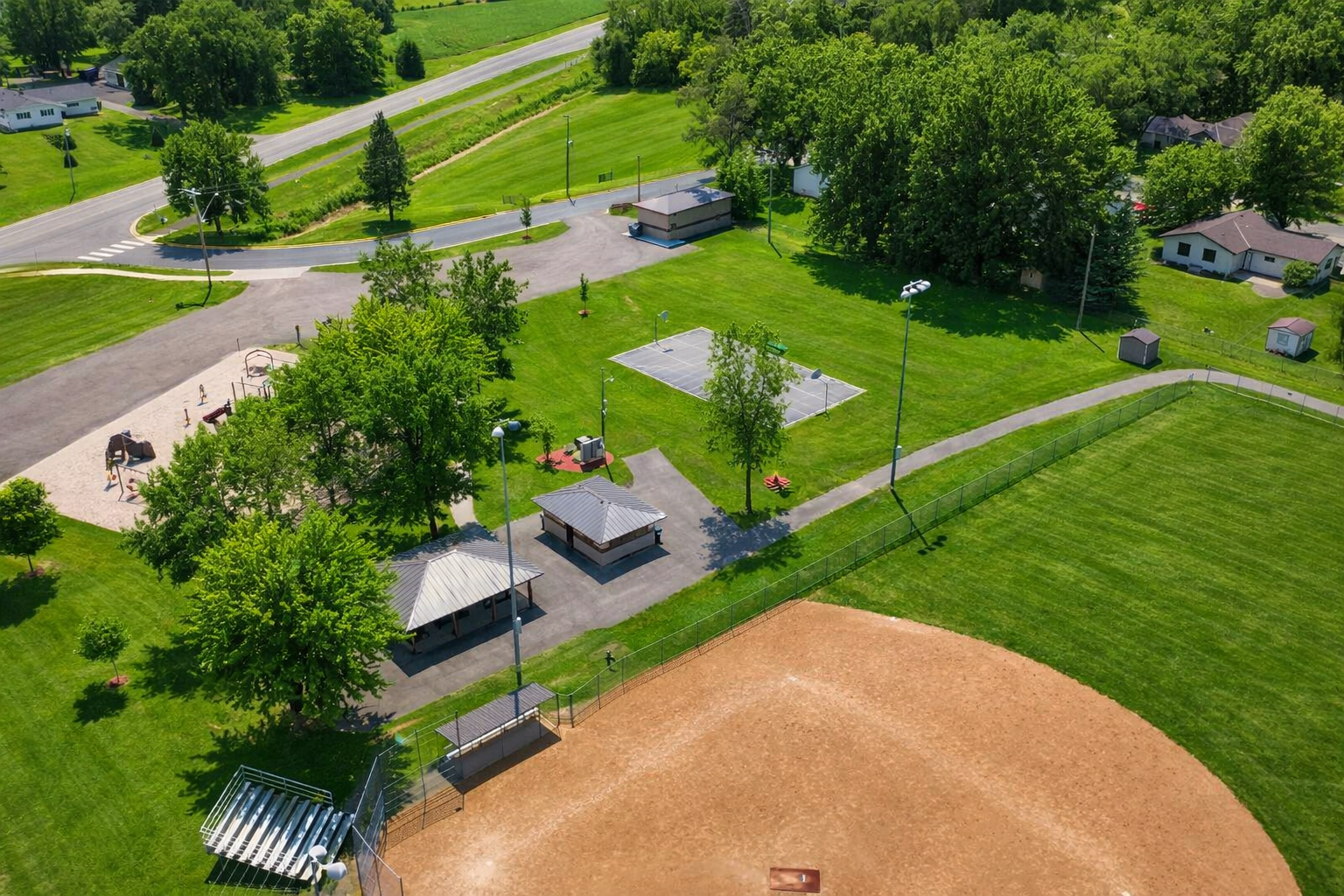 ball field, basketball court and playground next to home