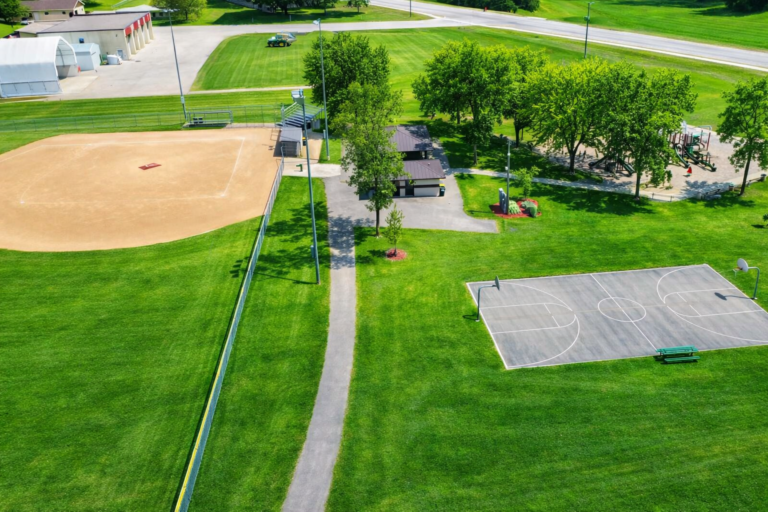Backyard next to basketball court, playground and baseball fieds