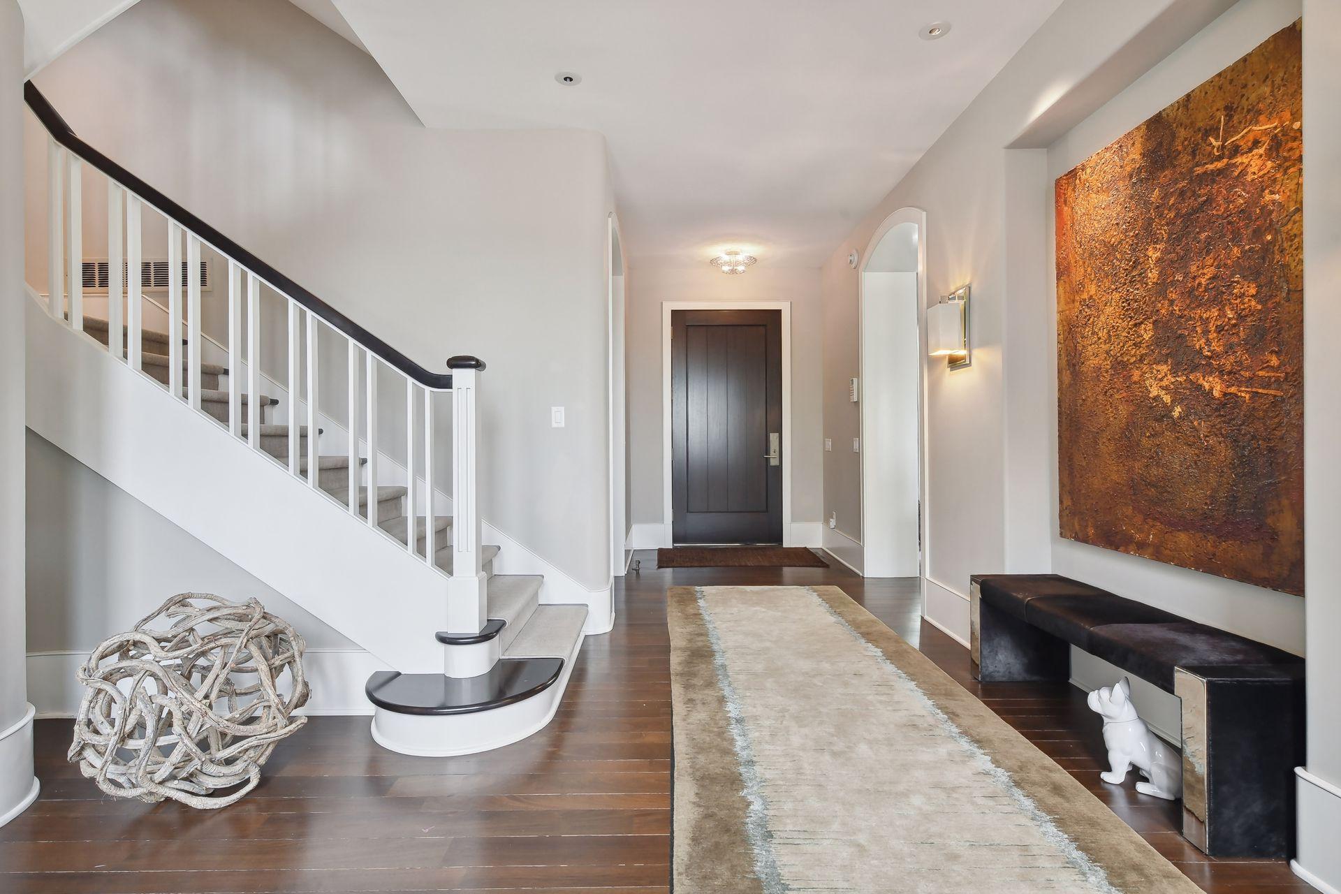 Back in the main entry foyer, a wide staircase leads to the upper floors