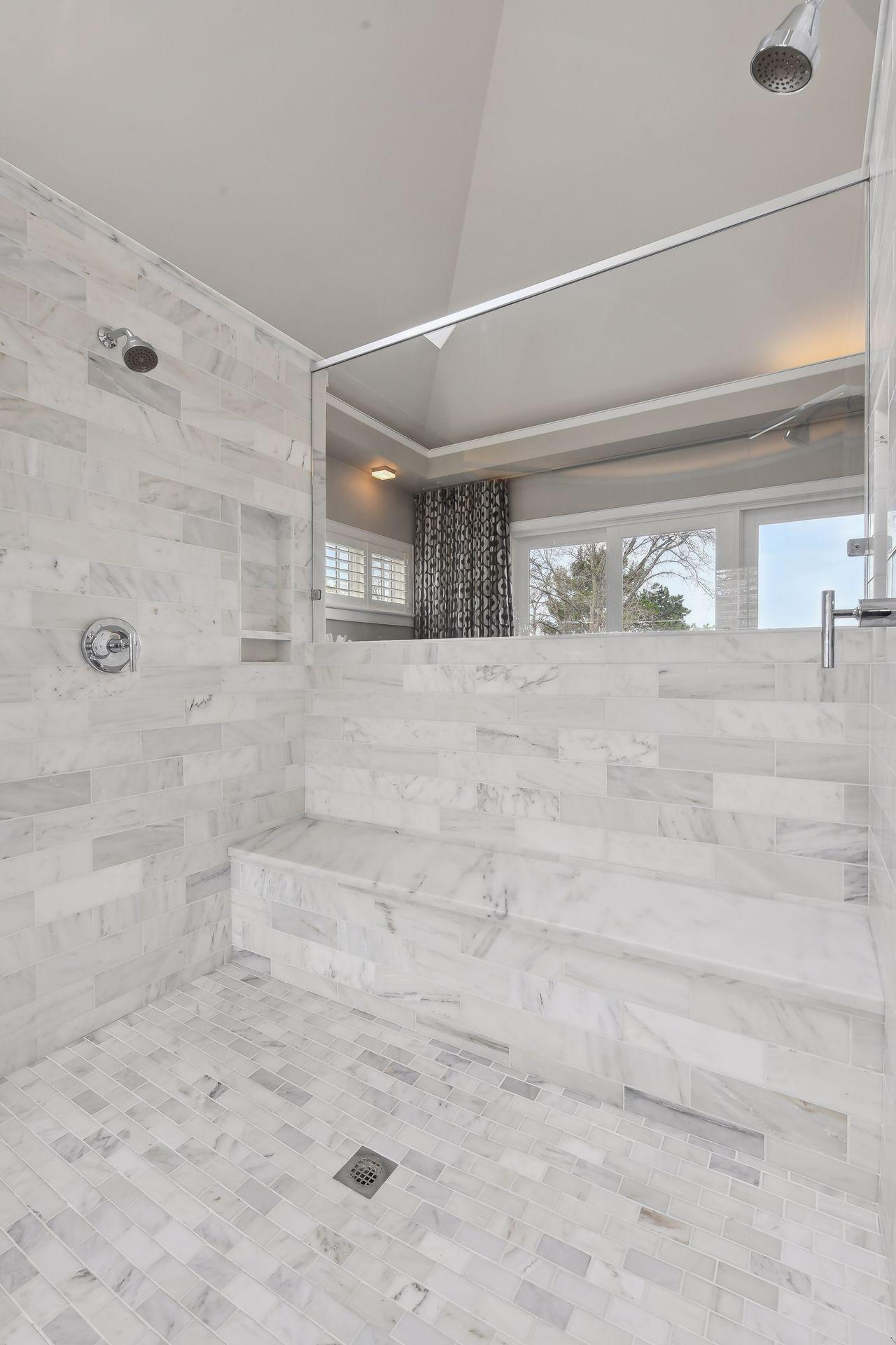 The large walk-in shower centered in the middle of the primary bath space makes quite the statement
