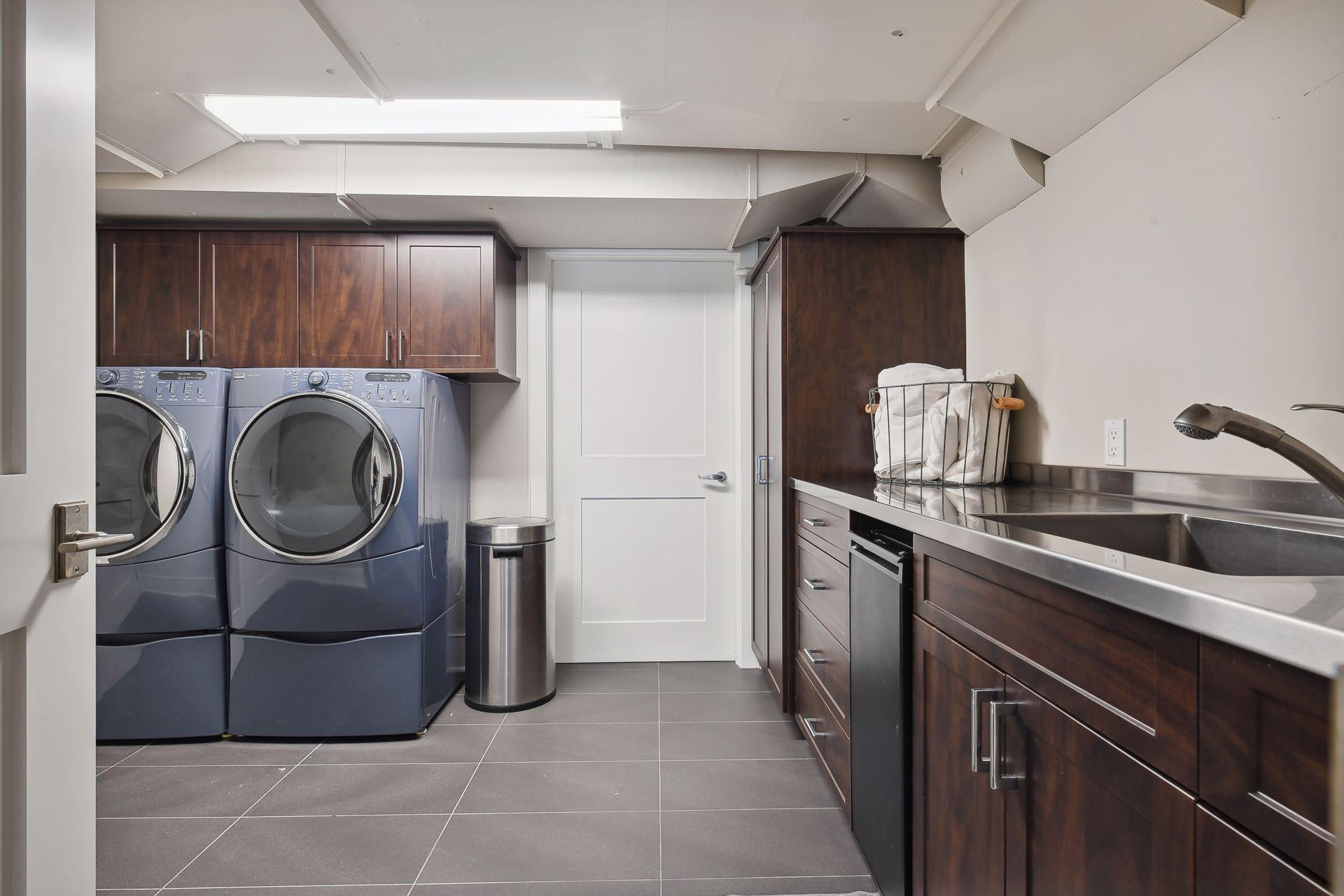 A secondary laundry room is found in the lower level