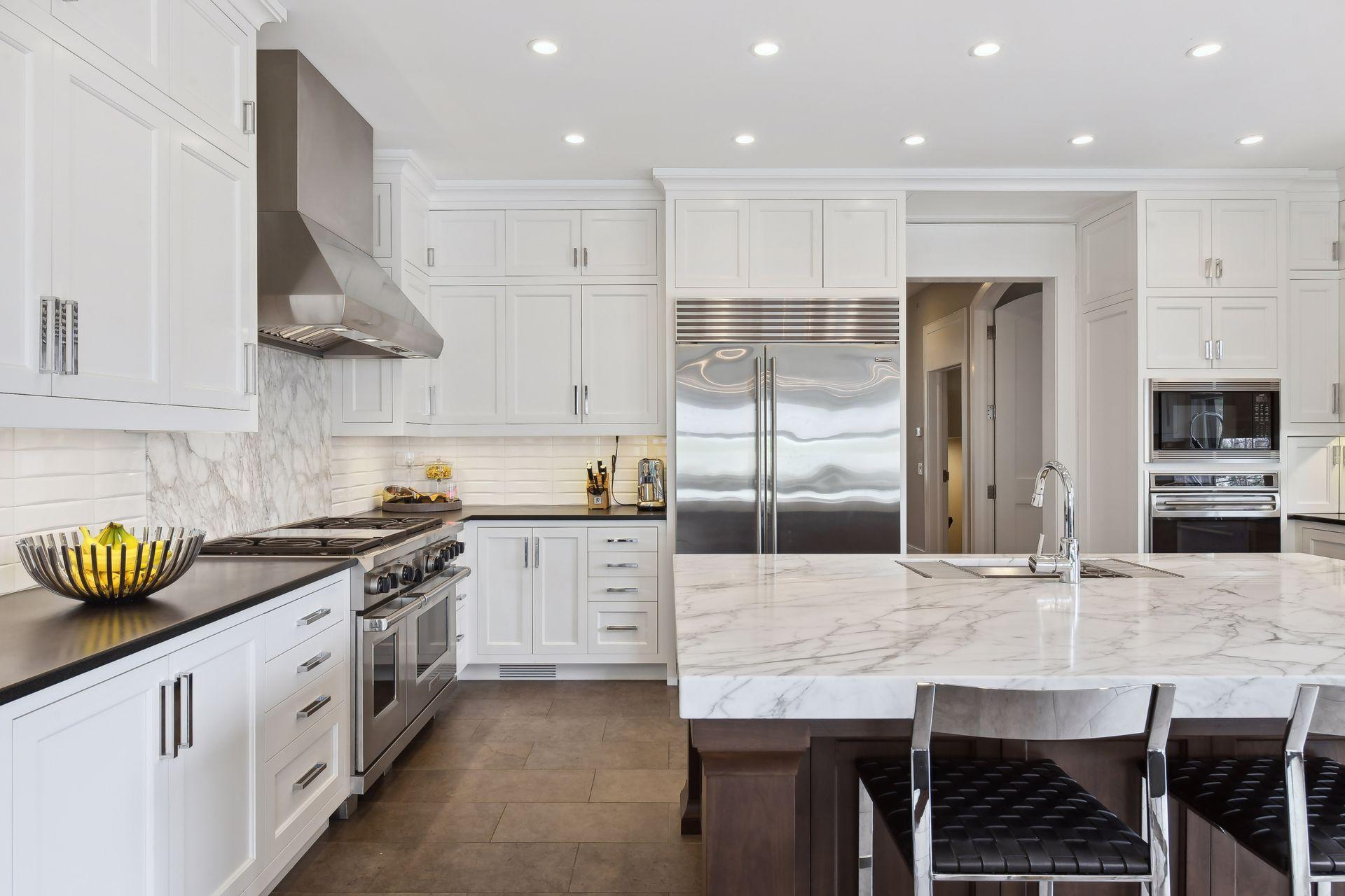 High-end SS appliances include a 6-burner gas range with dual ovens plus an additional wall oven and microwave