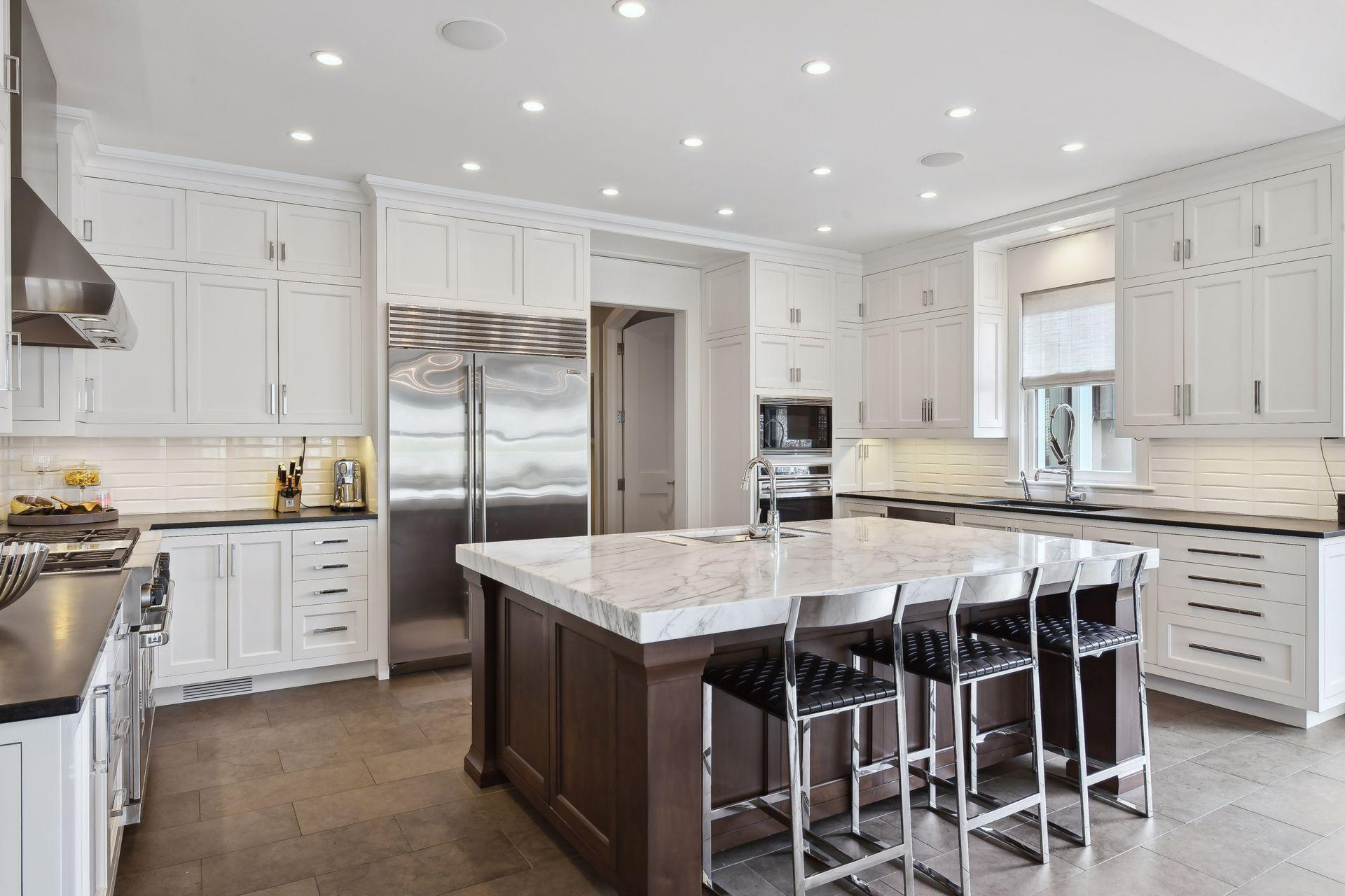 photo-A white and bright kitchen is part of the recent addition to the home.jpg