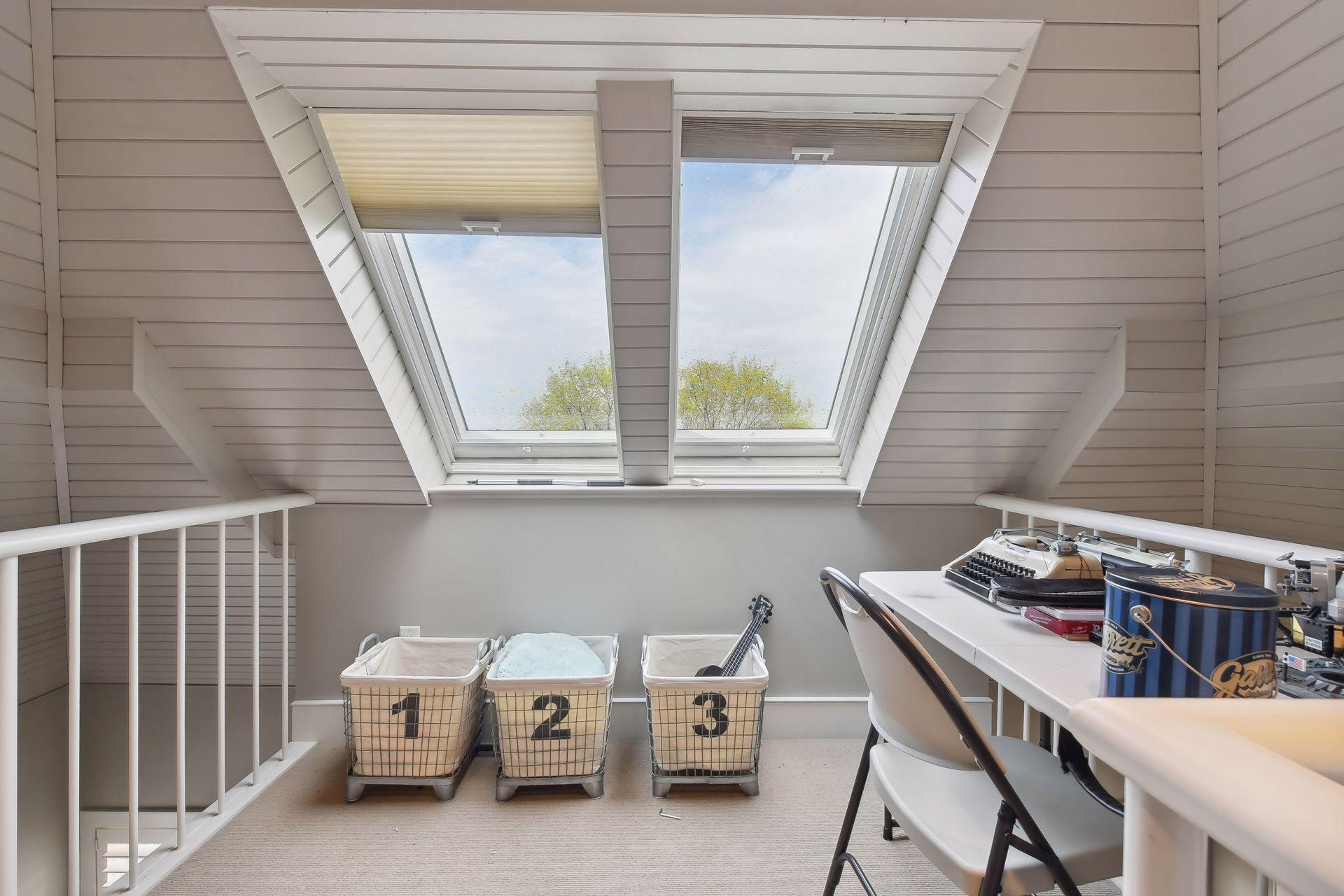 Bedroom loft area with skylights