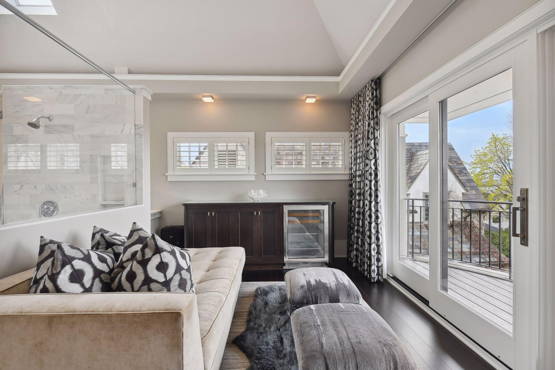 The primary bath includes a sitting area complete with a coffee/beverage bar and a private balcony with westernly views towards Lake Harriett
