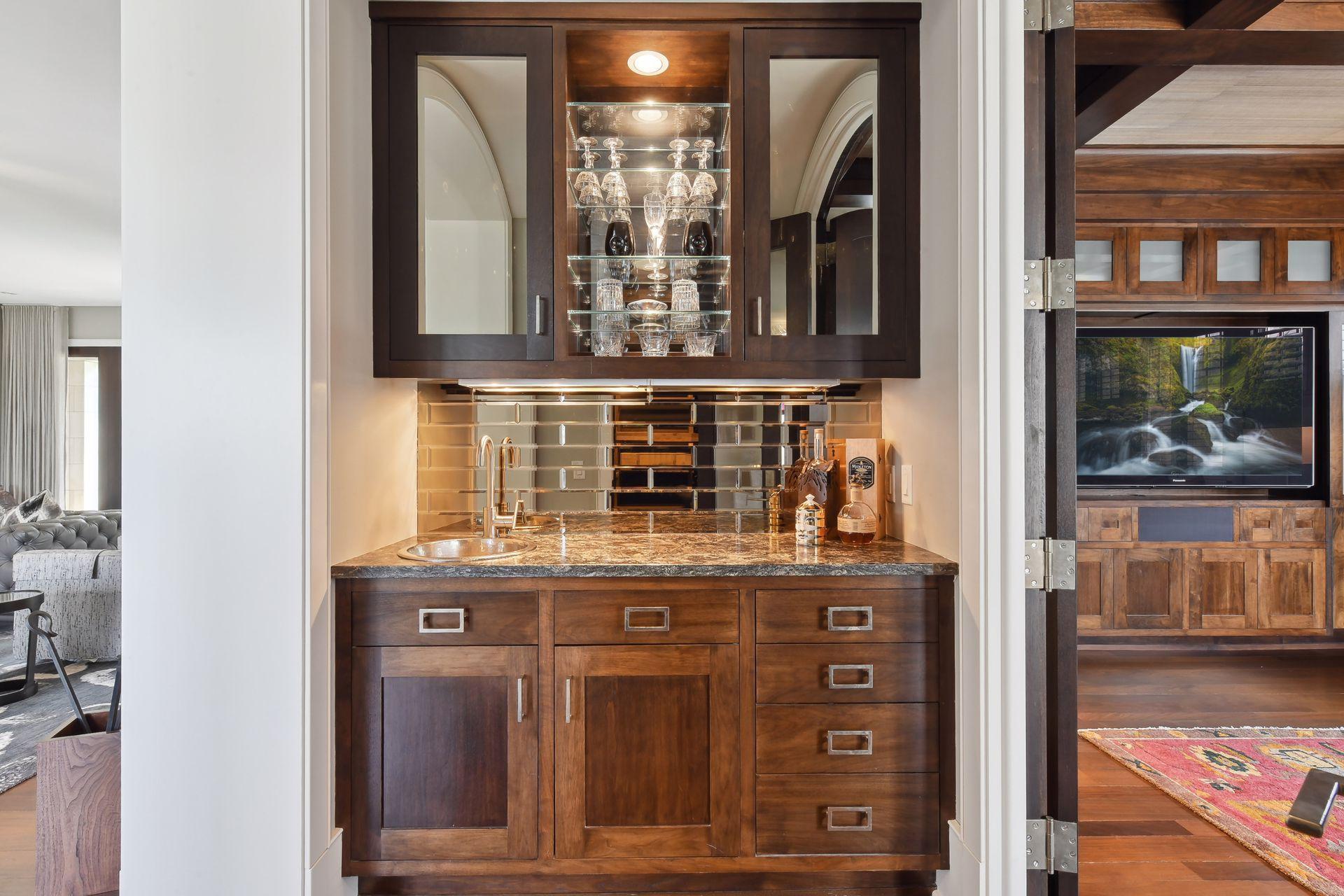 A butler's bar is conveniently located between the living room and media room, ideal for entertaining