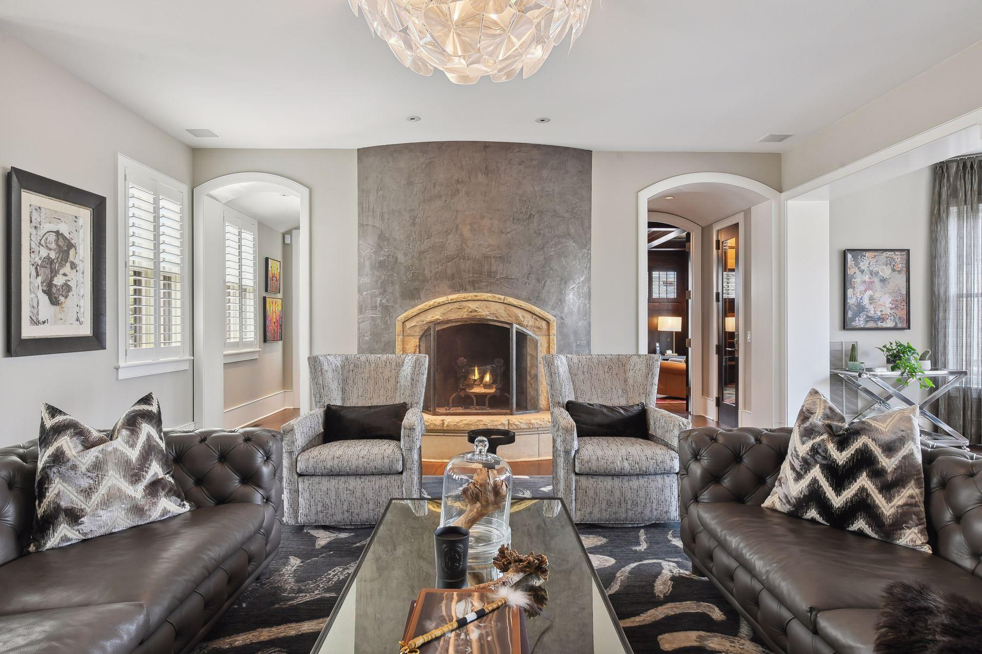 A wood-burning fireplace anchors one end of the formal living room