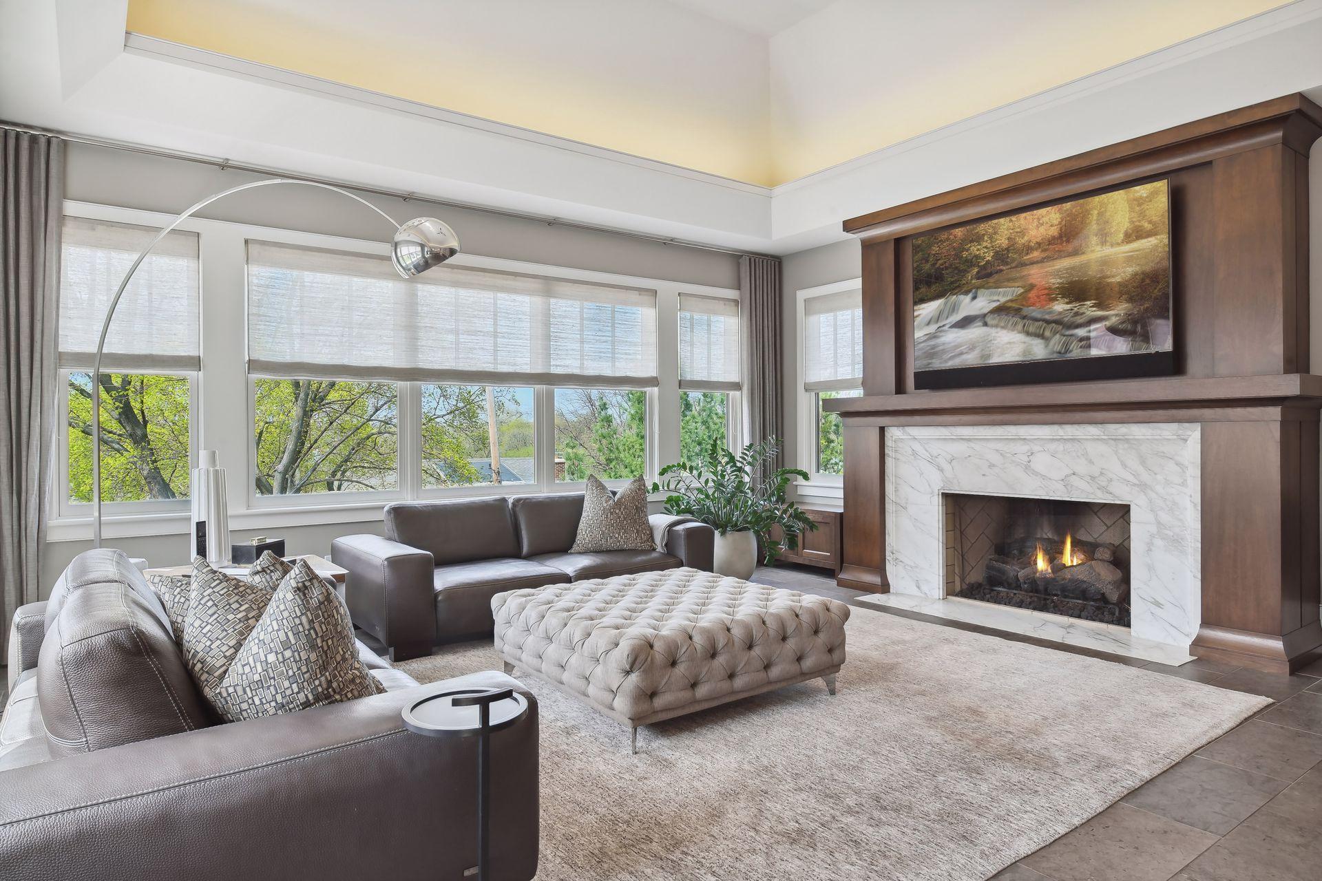 Cozy gas fireplace with beautiful rich wood surround, vaulted ceilings with ambient lighting, and views of the outdoors are a few highlights of this spacious family room