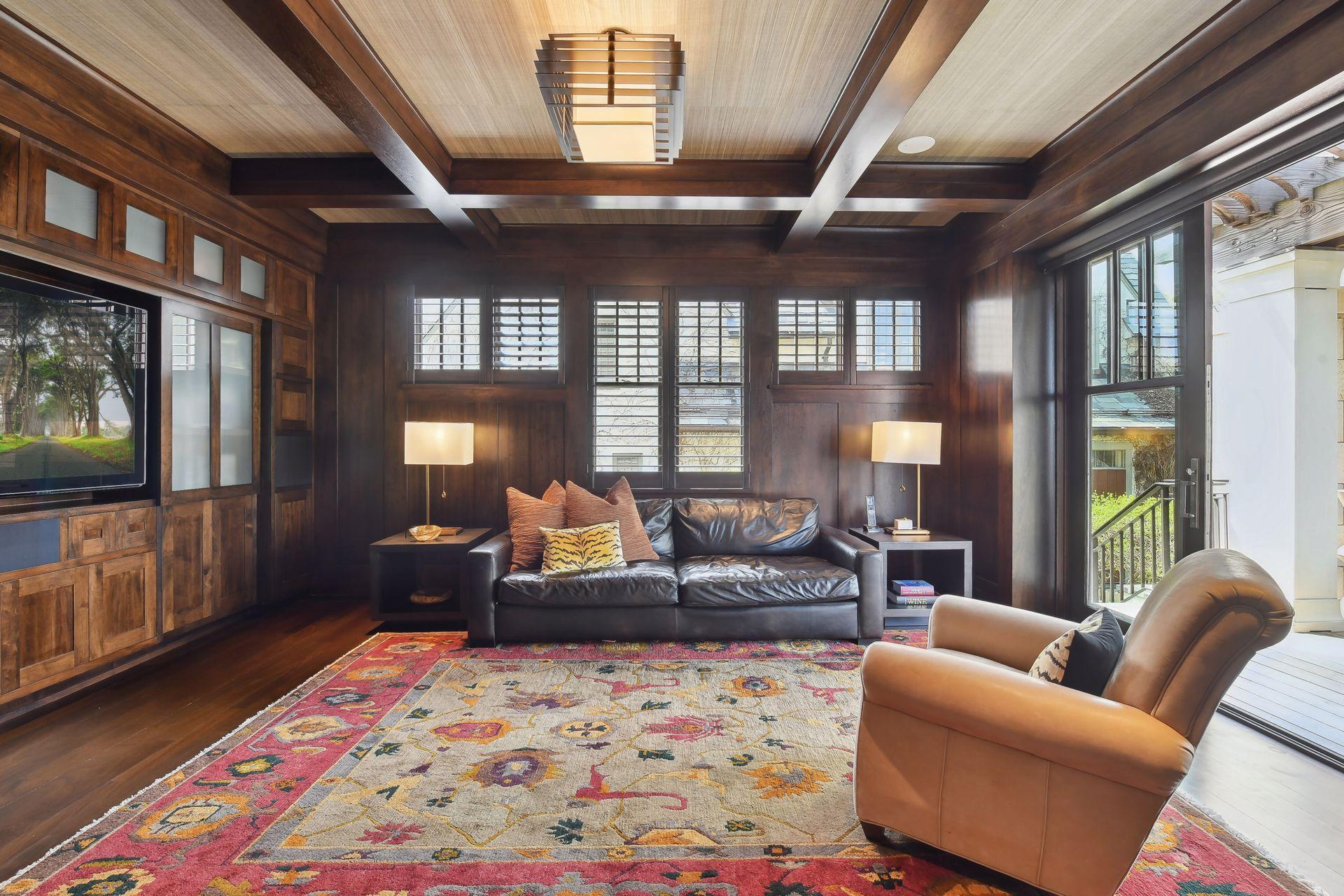 The living room flows into a warm and inviting media room