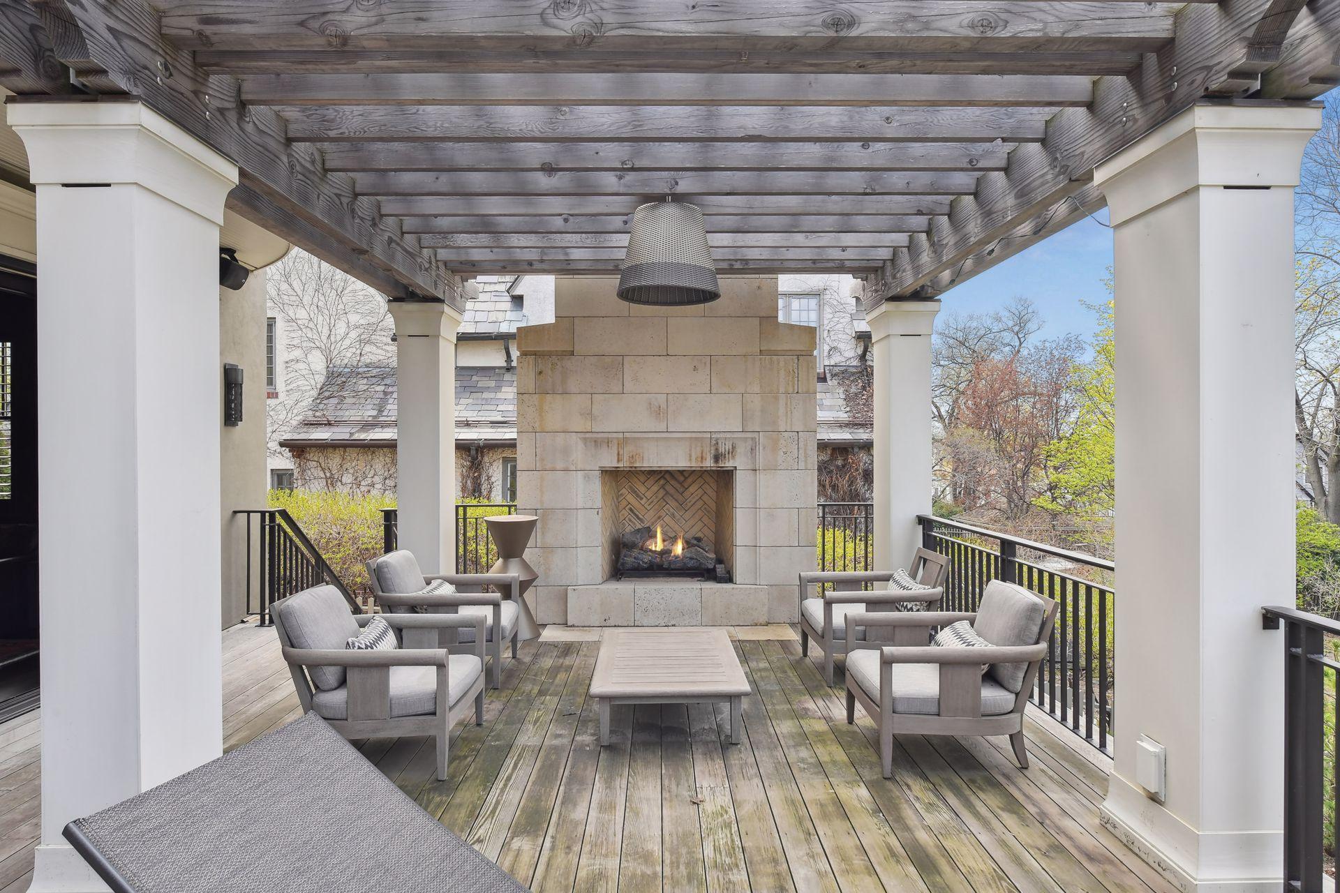 A gas fire place offers a bit of warmth on cooler days and nights when enjoying the pergola-covered outdoor space off the media room