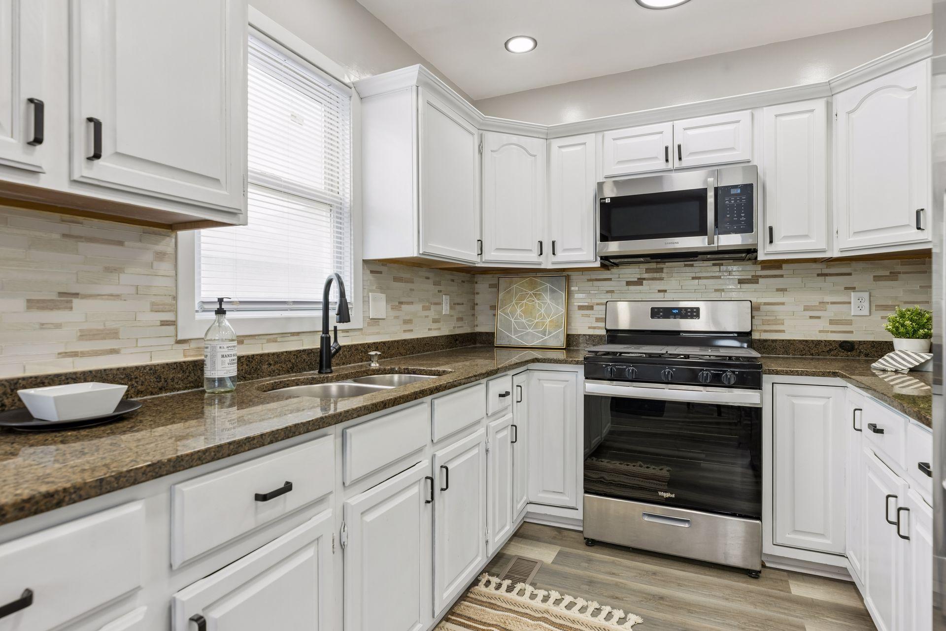 Updated stone countertops and tiled backsplash