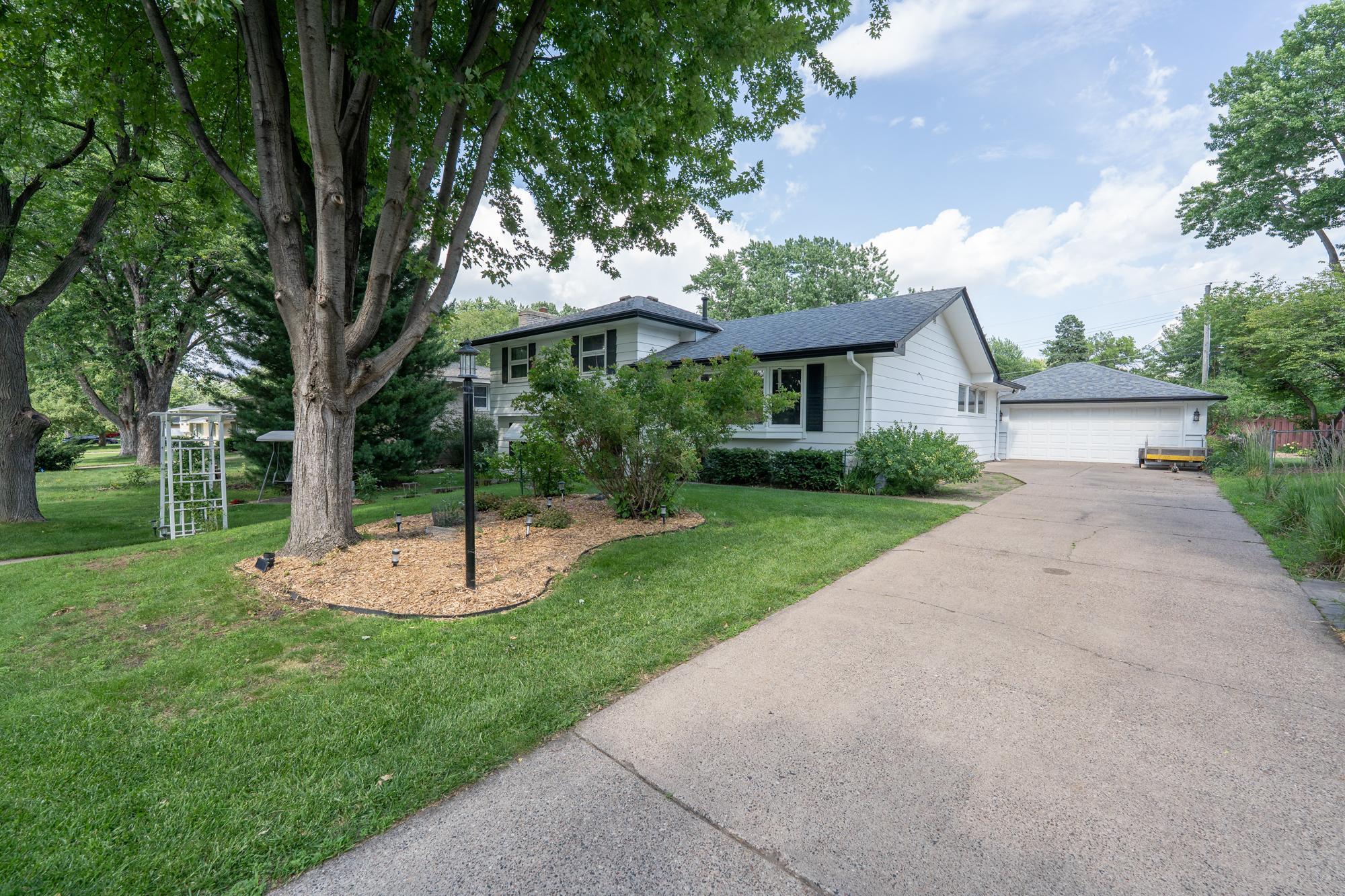 As you can see you have a very nice driveway with ample parking. Beautiful mature trees, landscaping and a large 2 car garage. Roof is only 11 years old