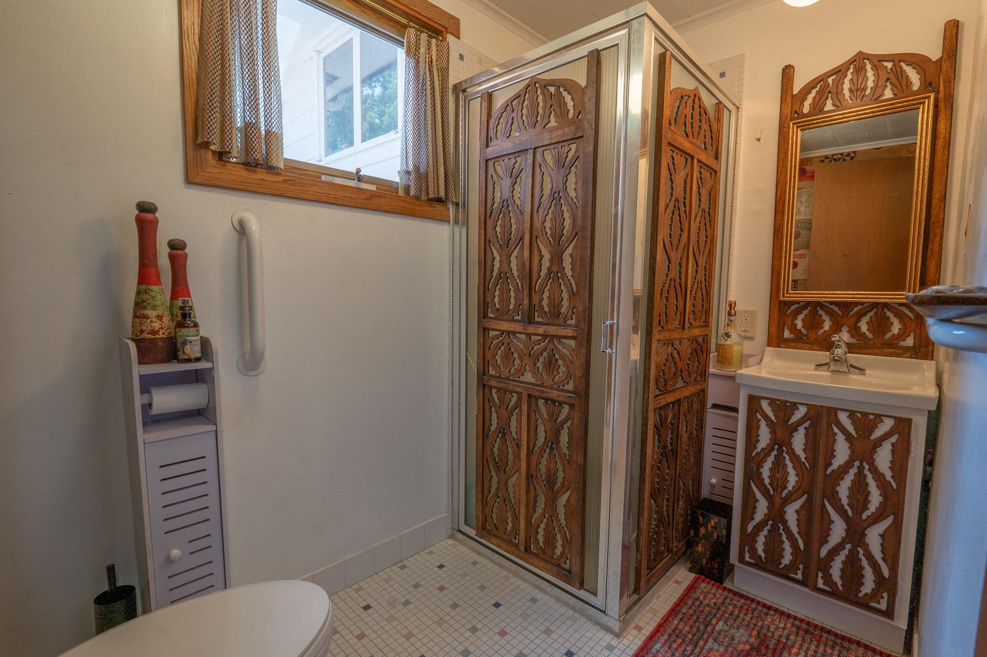 This is the three quarter bath with a shower, sink and toilet. Tile floors. Right down the hall from the family room and wet bar