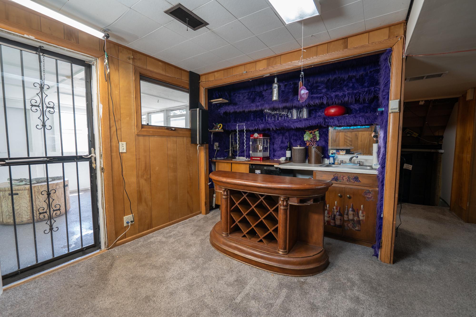 This is the wet bar right off of the family room behind it is a three quarter bathroom and to the left is the door that goes to the three season porch which leads to the private backyard. This is a wonderful spot to entertain. Dubbed Hotel California