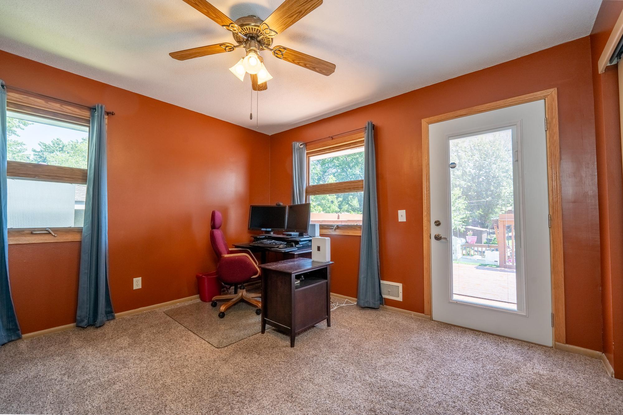 This bedroom is currently being used as a Home Office and the door leads to the deck and the backyard. You have beautiful views from this room of the very private backyard