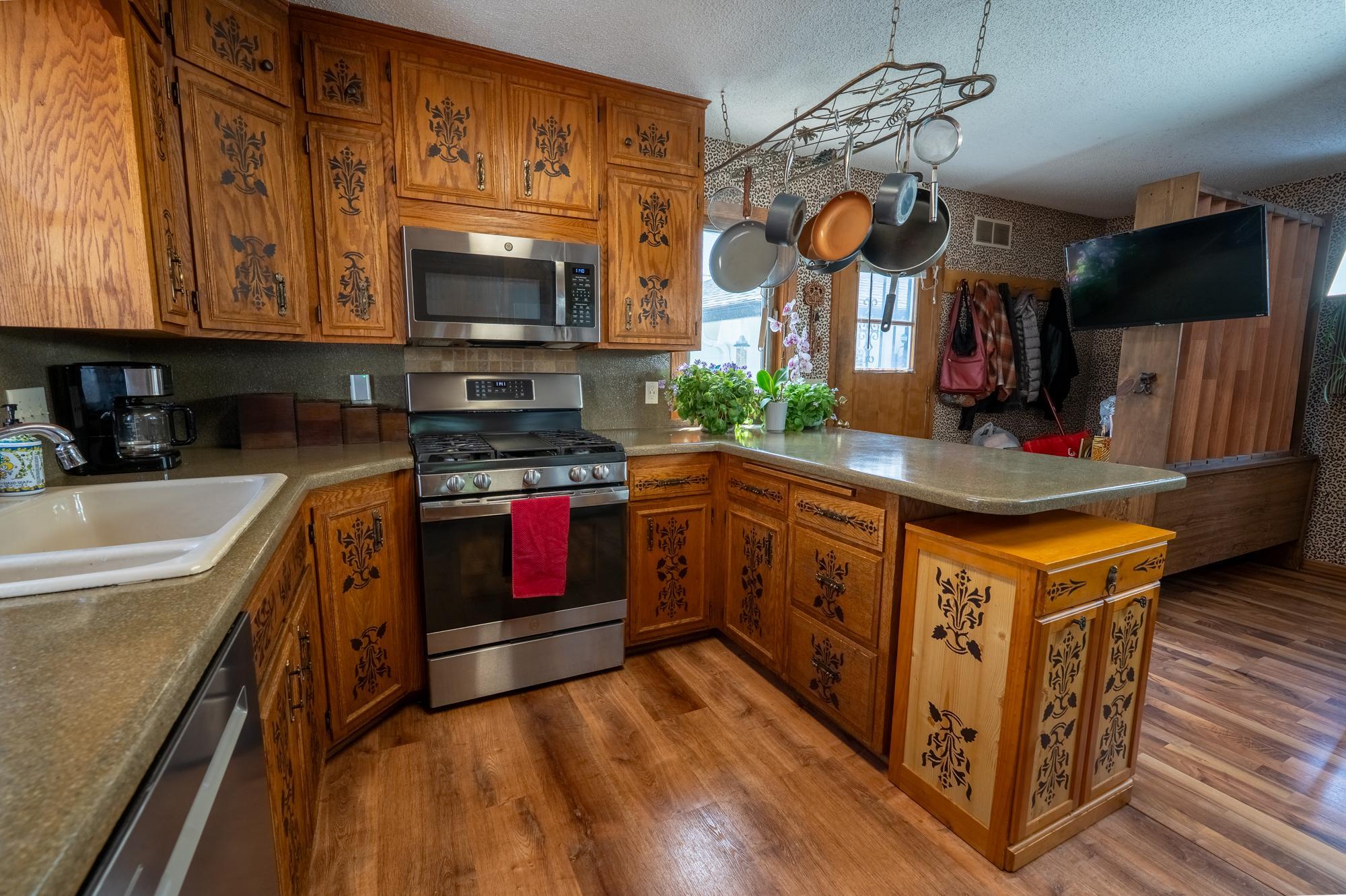 Spacious kitchen with a beautiful flooring, lots of cabinets for storage, countertop space, stainless steel appliances and an open floor plan with a formal dining room right across the hall