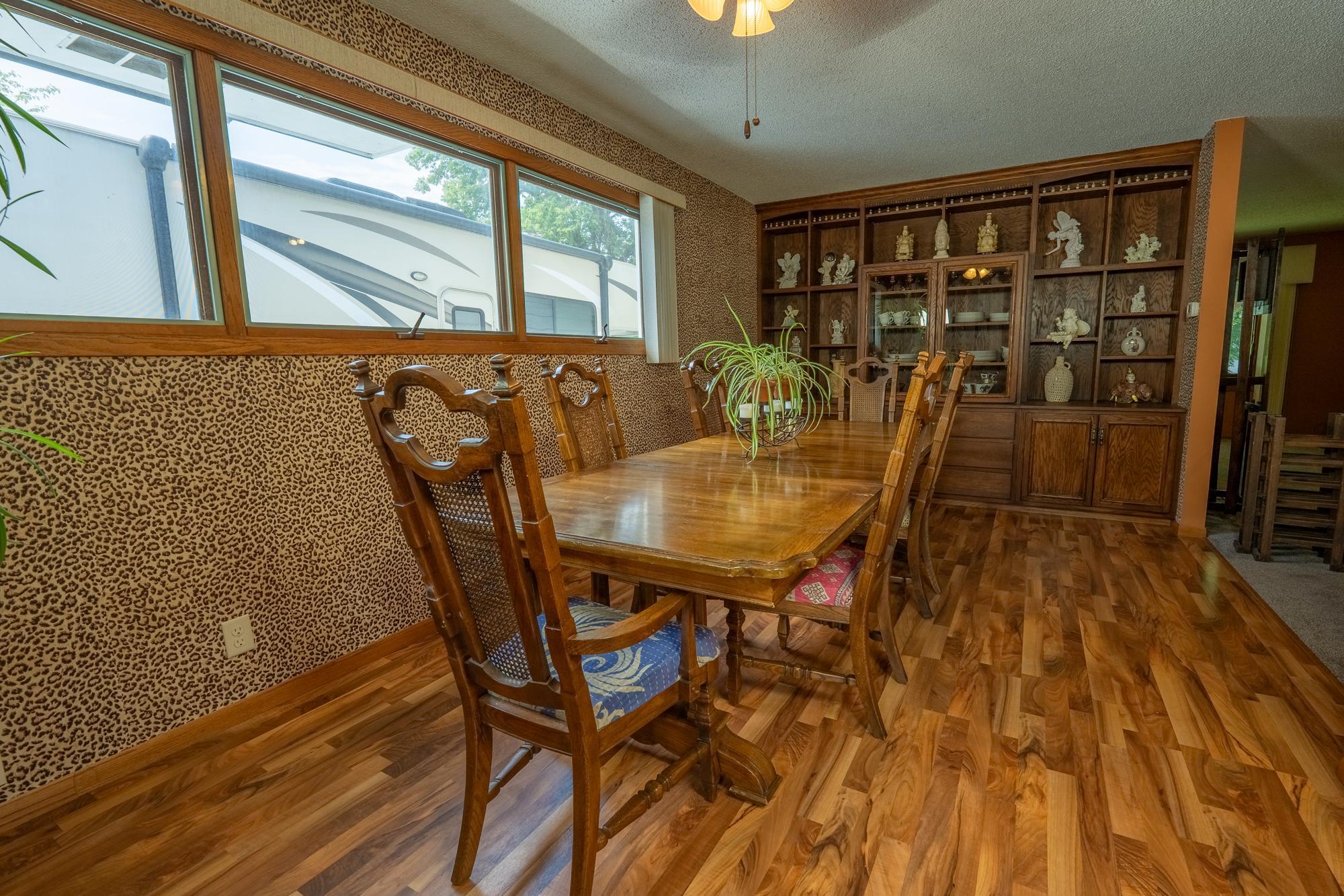 This is the formal dining room right off the kitchen there's lots of natural light throughout the day because of the large windows. Just to the right of this past the kitchen is an informal dining area.