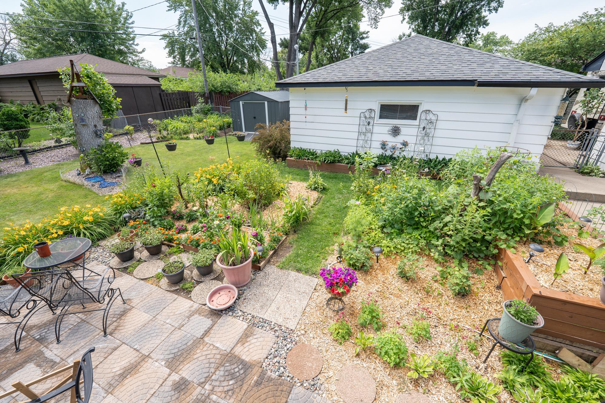 Here's another view from the deck overlooking the backyard. The patio as well as all the beautiful perennials and annuals. The owner has specifically designed this to be very easy to care for. If you're a gardener this is perfect for you!