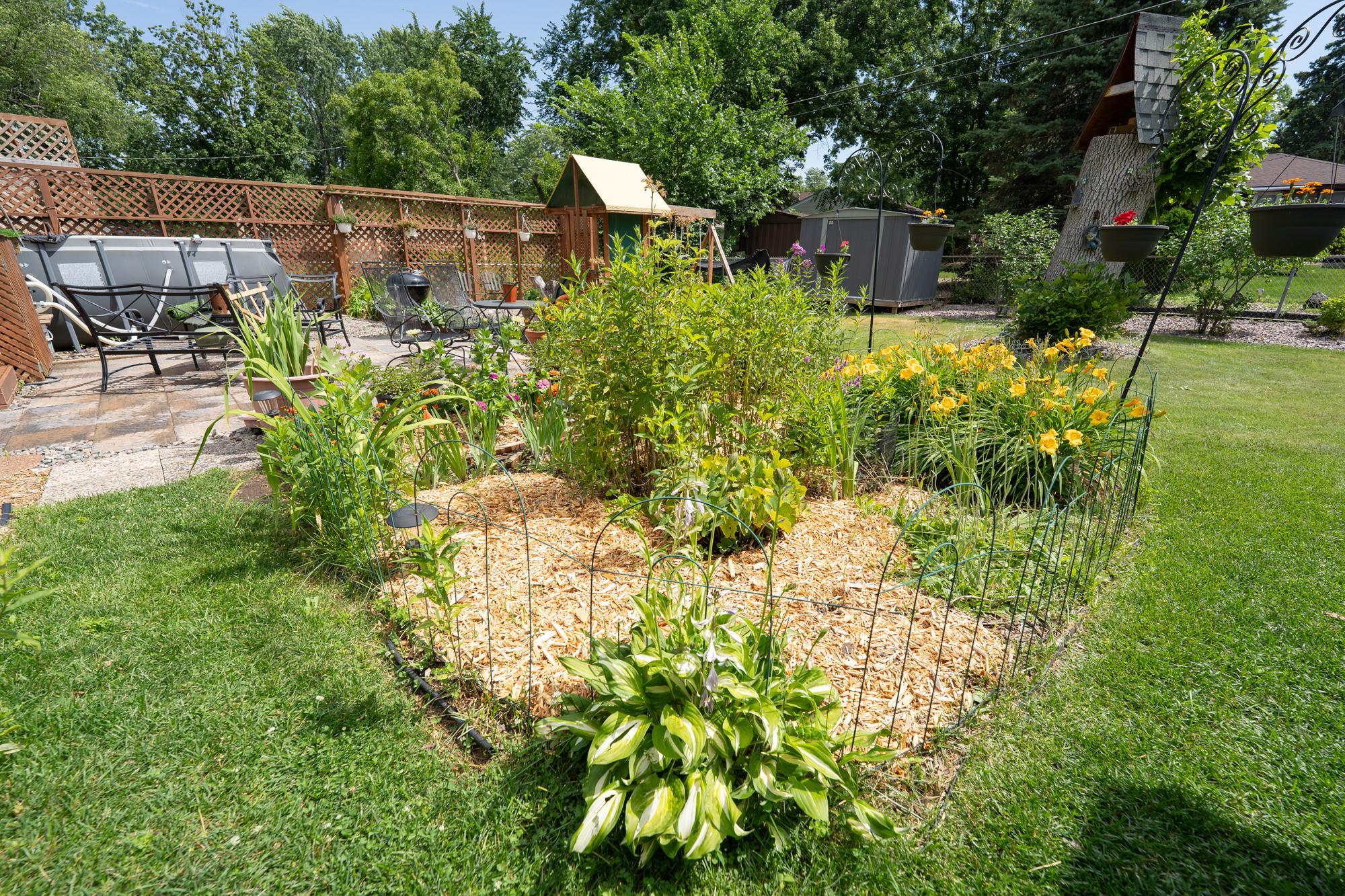 Although there are a lot of beautiful plants and flowers that bloom from spring through fall there's plenty of open space in the backyard for any type of outdoor activity.