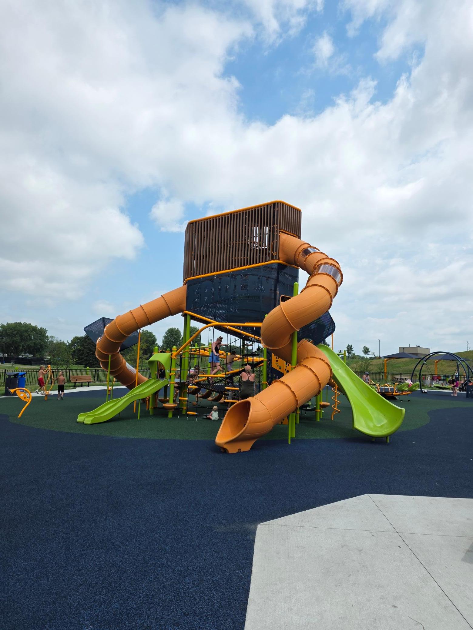 This is just one section of a huge play area for the kids and all the dark material you see is all reinforced rubber. If they fall off the swing or come down the slide too fast, they don't get hurt. It's state-of-the-art.