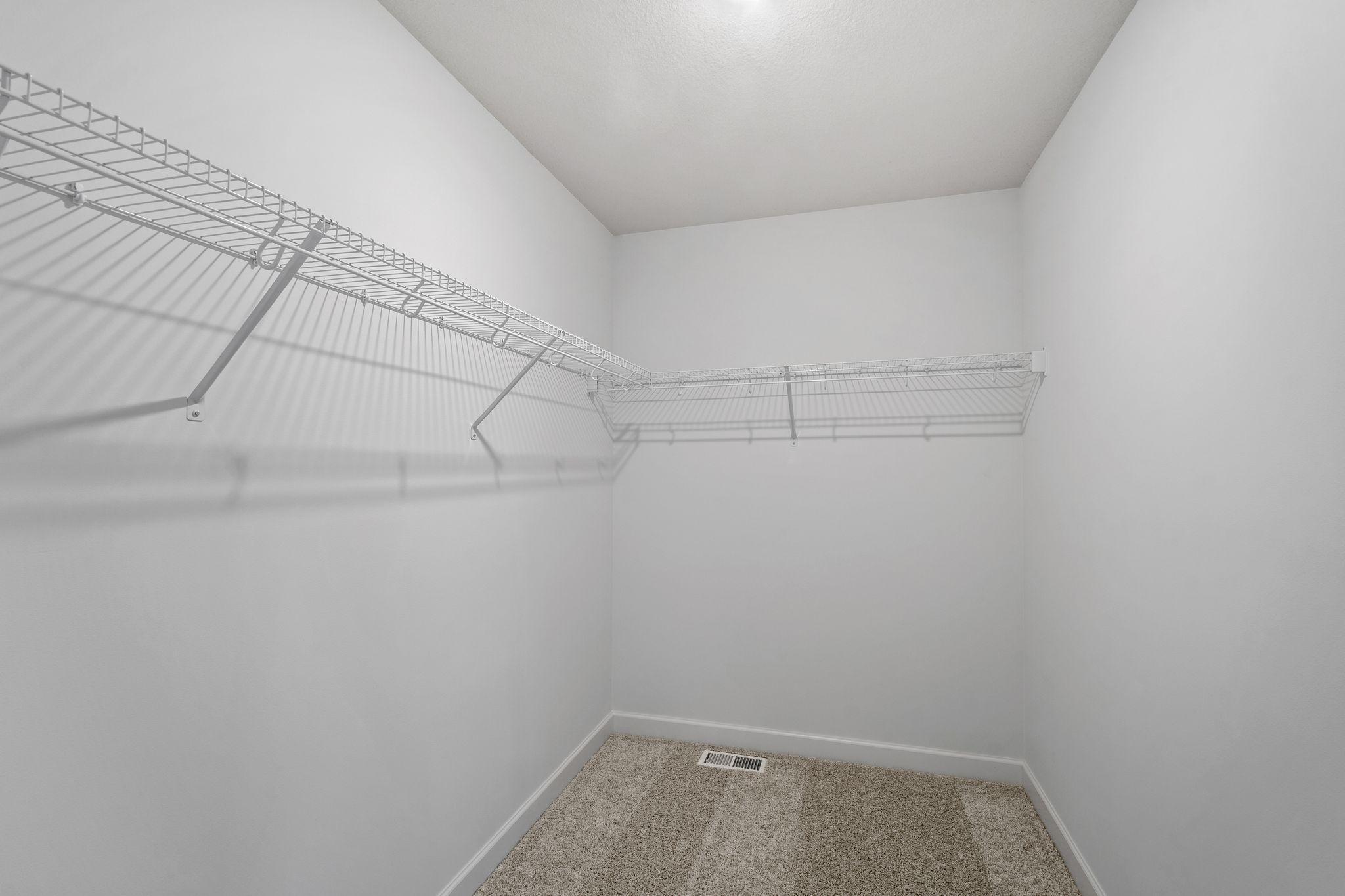 Ventilated shelving is featured in the walk-in closet