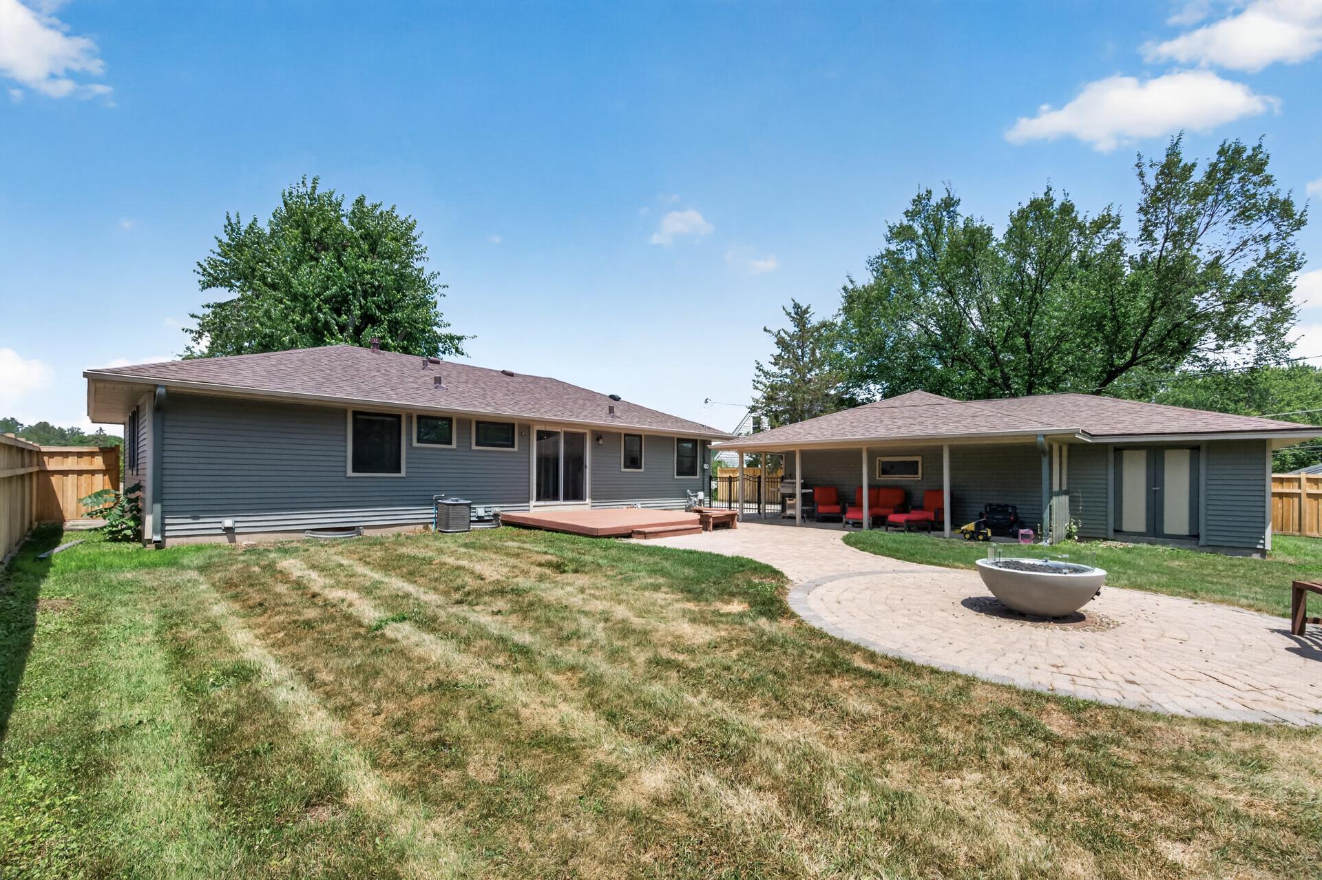 Backyard with a paver patio, deck, covered patio, and fully fenced in!