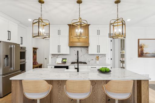 (Photo of an inventory home, actual homes finishes will vary) The stunning kitchen features a large center island perfect for hosting!