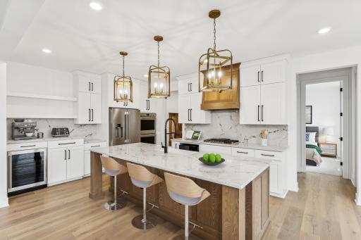 (Photo of an inventory home, actual homes finishes will vary) The stunning kitchen features a large center island perfect for hosting!