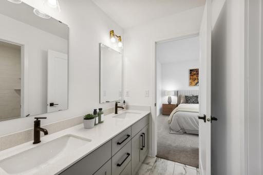 (Photo of an inventory home, actual homes finishes will vary) This Jack and Jill bath connects two of the upper level secondary bedrooms.