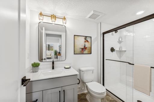 (Photo of an inventory home, actual homes finishes will vary) The lower level bath.