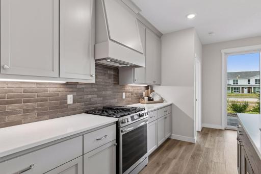 Custom cabinetry and decorative tile backsplash