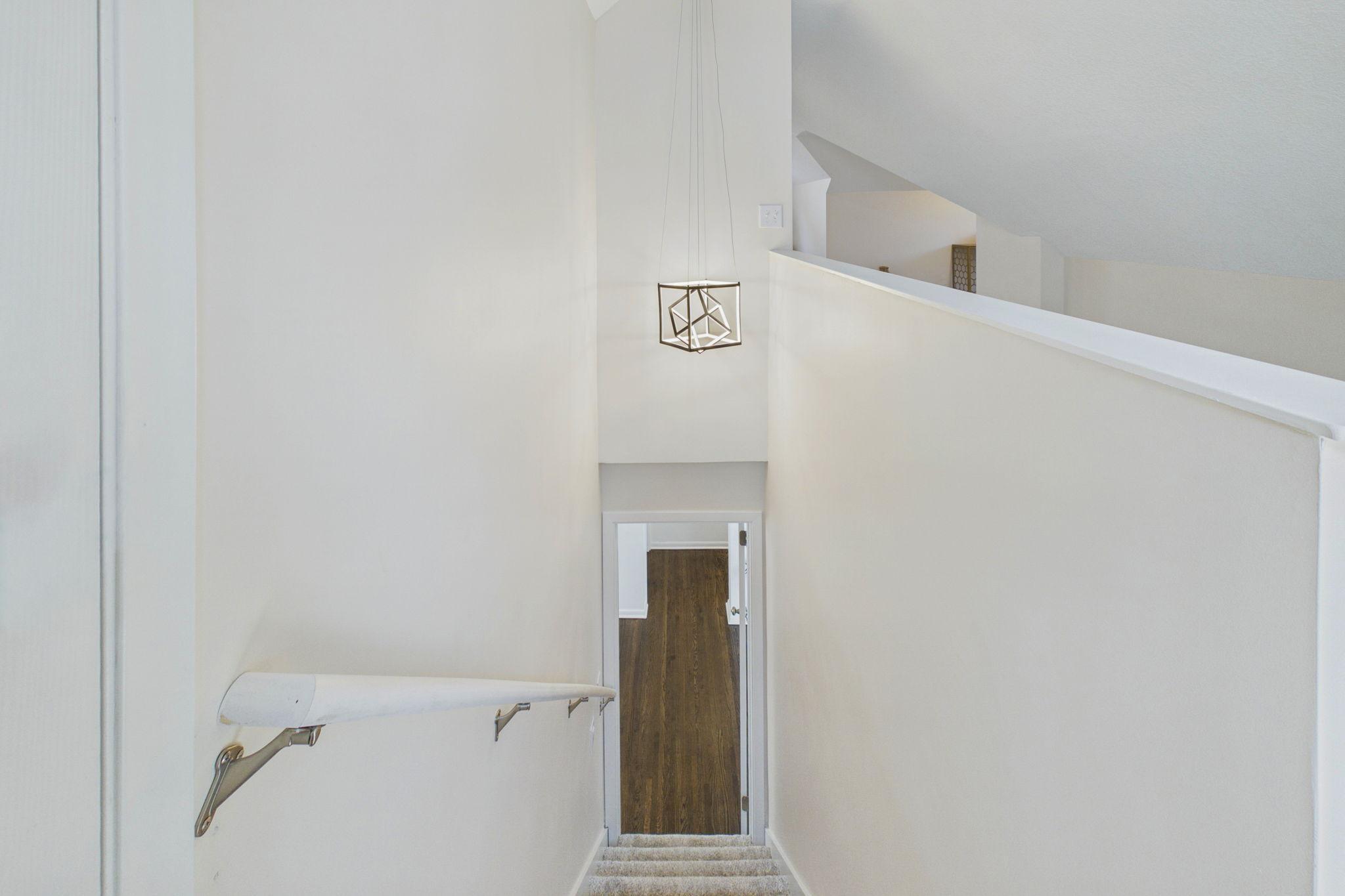 View from top of the stairs looking down to the dining room.