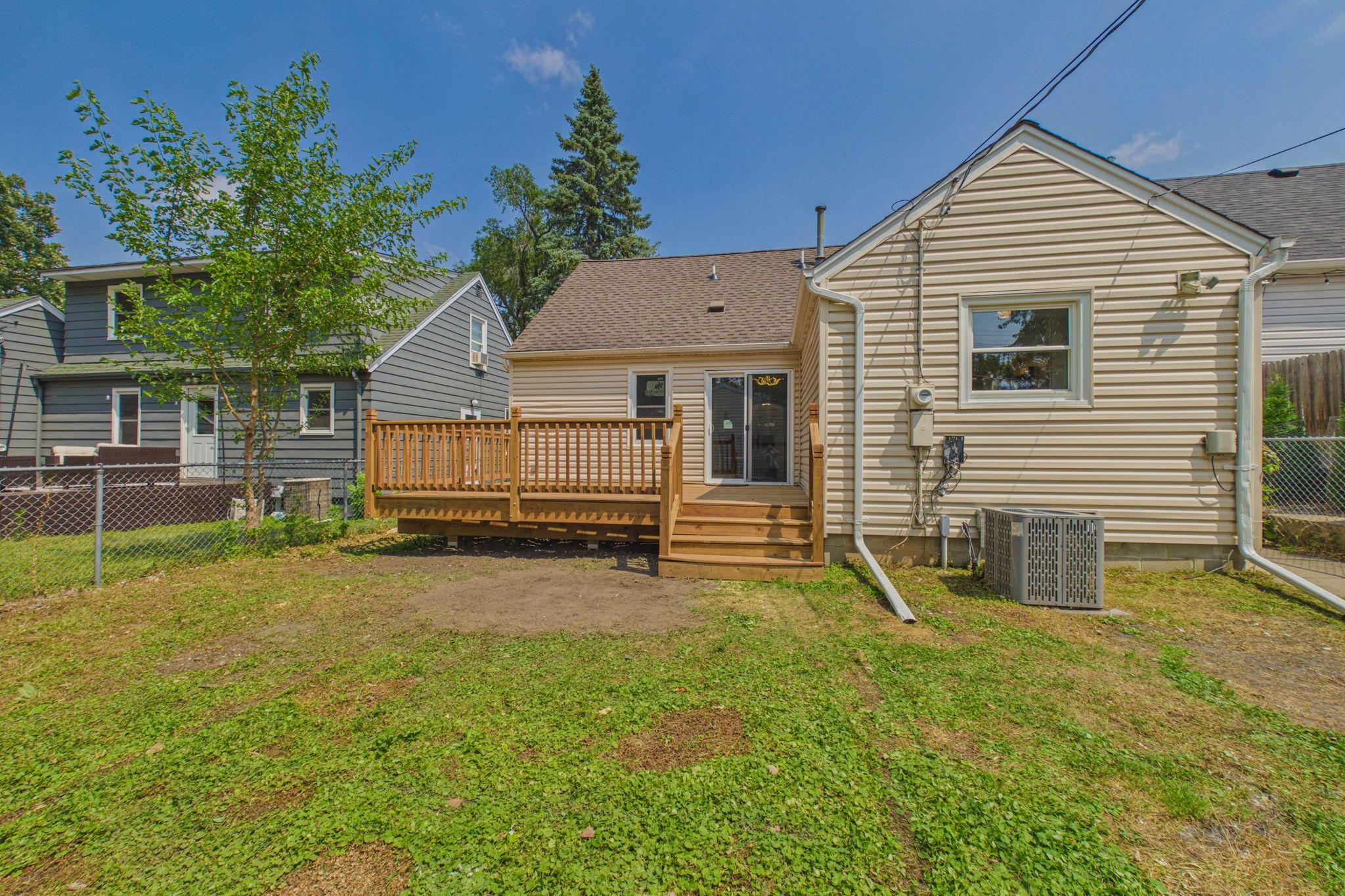 View of backyard and new deck from garage.