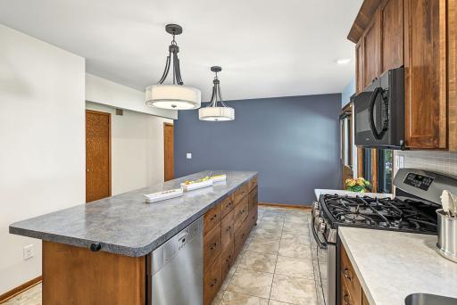 On the right, the kitchen door leads to a backyard patio, a perfect set up for entertaining!