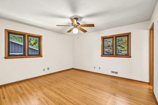 Primary bedroom with gleaming original hardwood floors.
