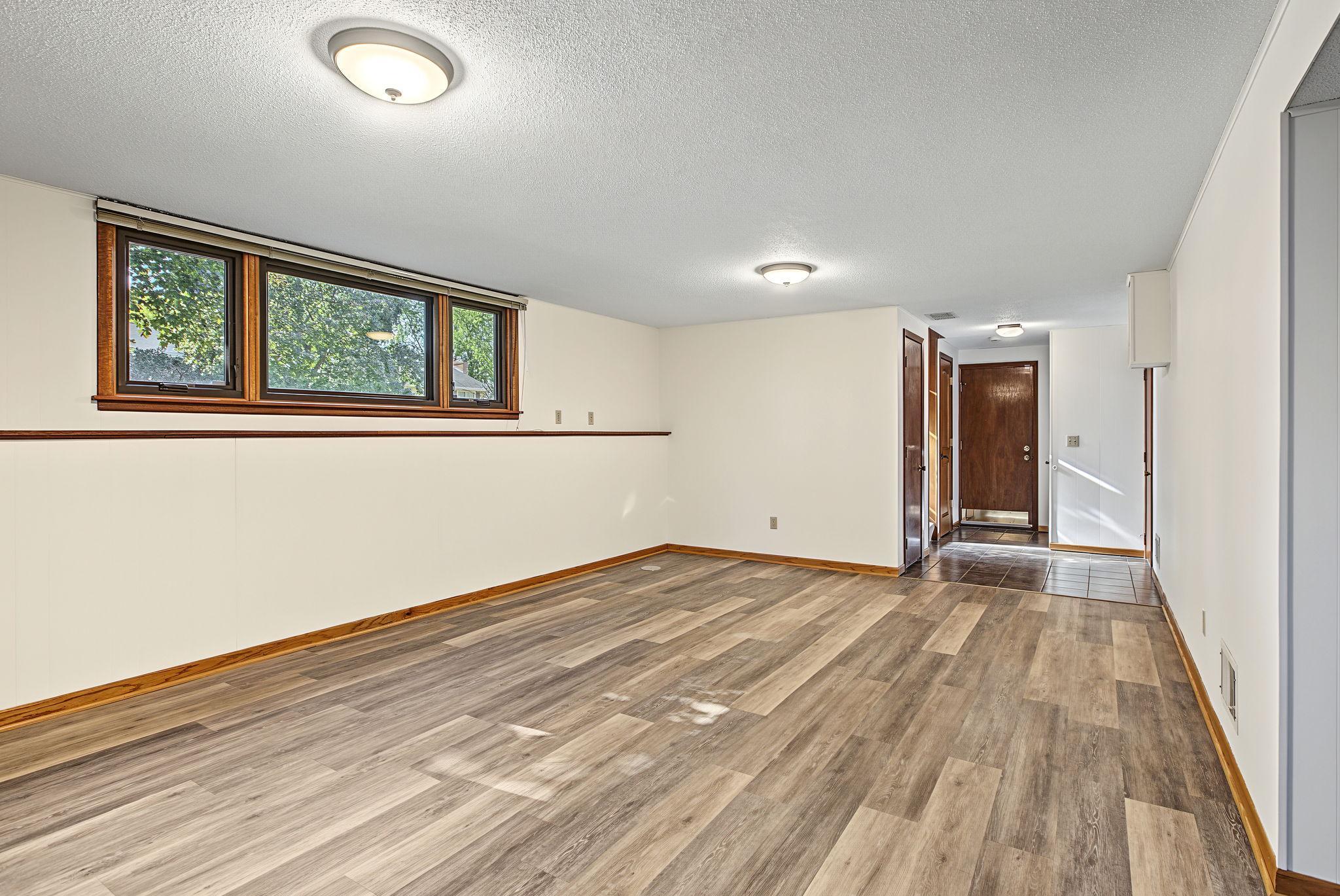Entry area off the garage has newer tile flooring and multiple closets.
